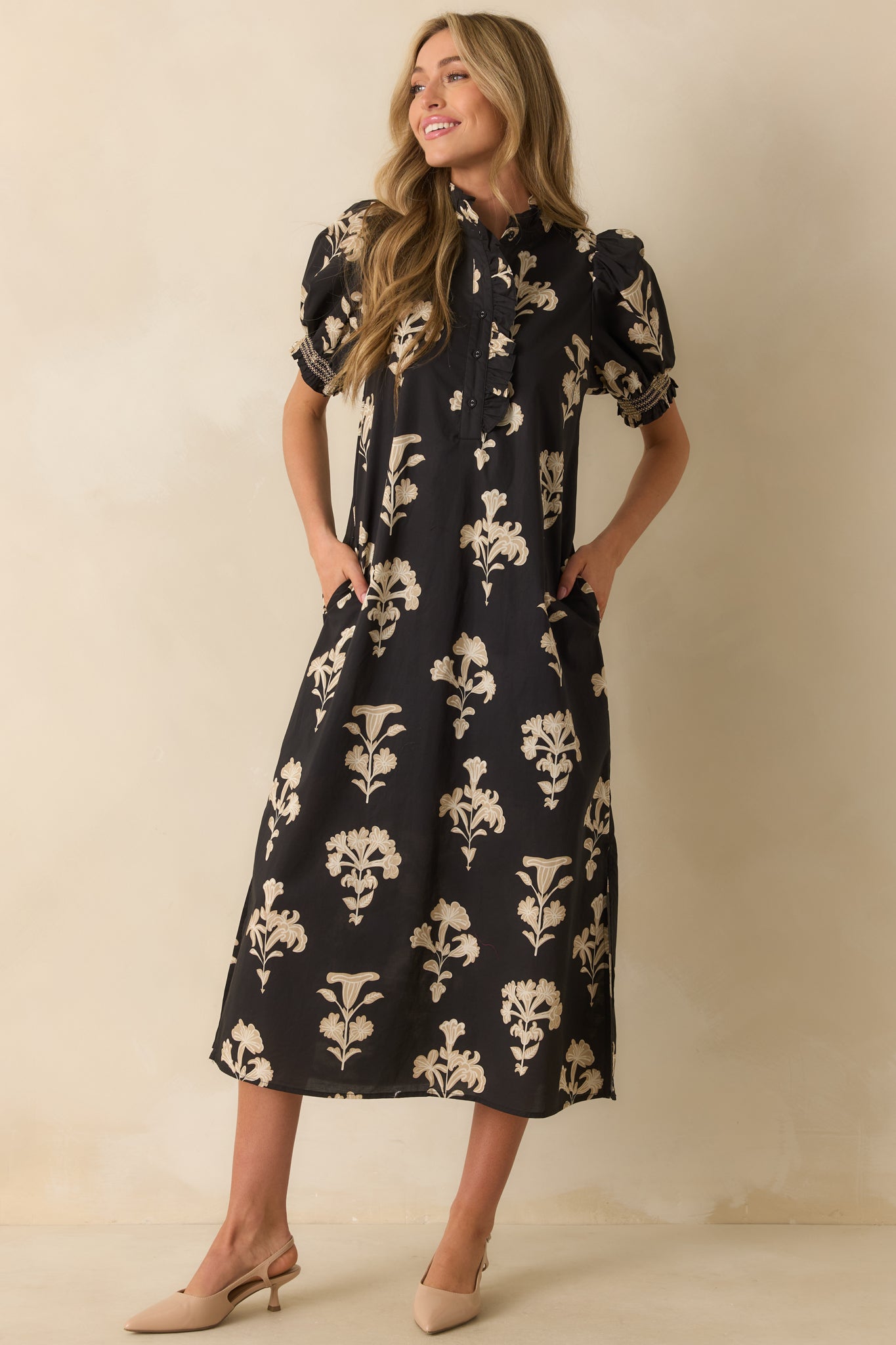 Black floral dress highlighting the ruffled neckline, button-front design, and breezy floor-length skirt.