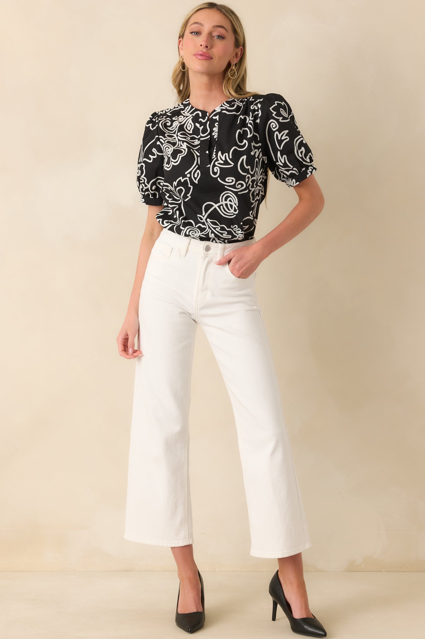 A full-body posed shot drawing attention to the puff sleeves and overall movement of the cotton top.
