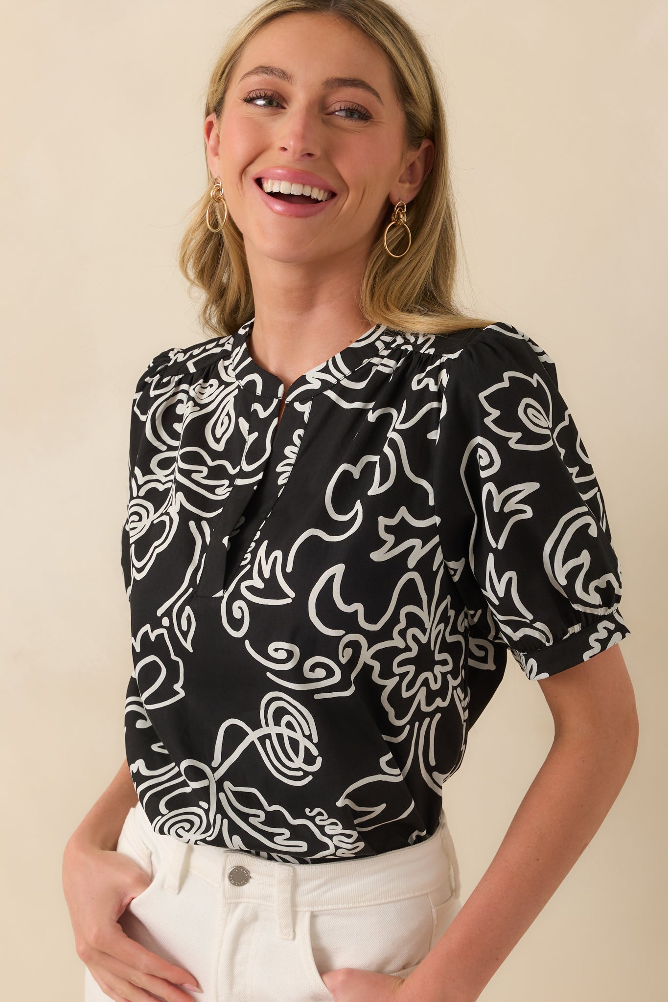 A close cropped side angle showing the gathering on the short puff sleeve and the texture of the lightweight cotton material.