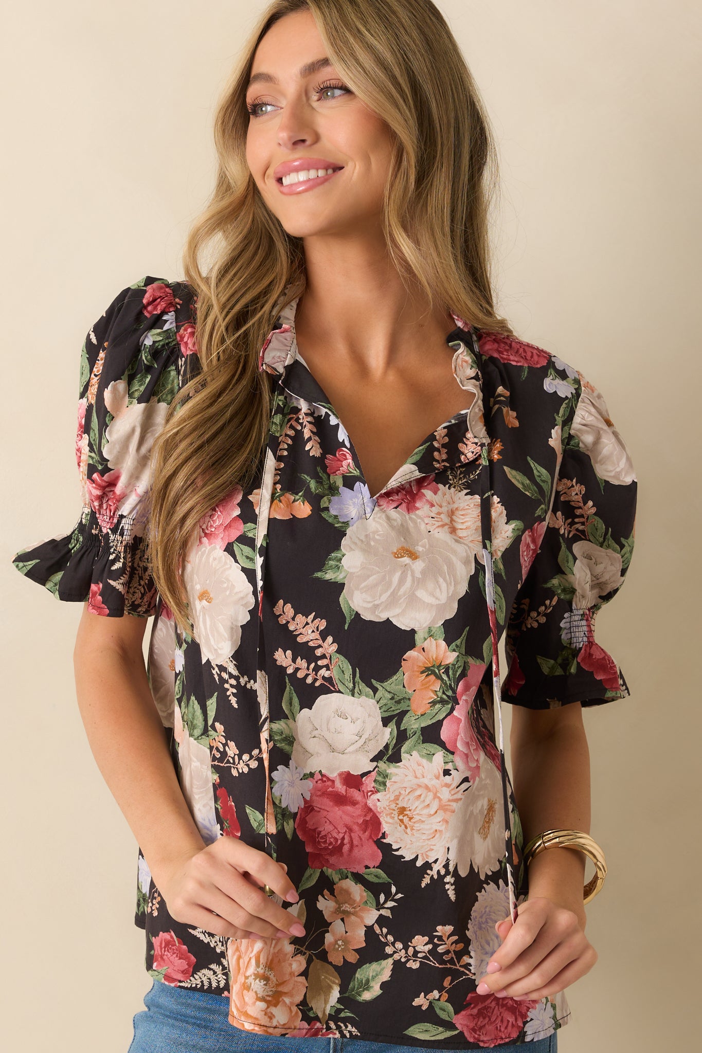 Black floral top focusing on the vibrant print and sleeve detailing.