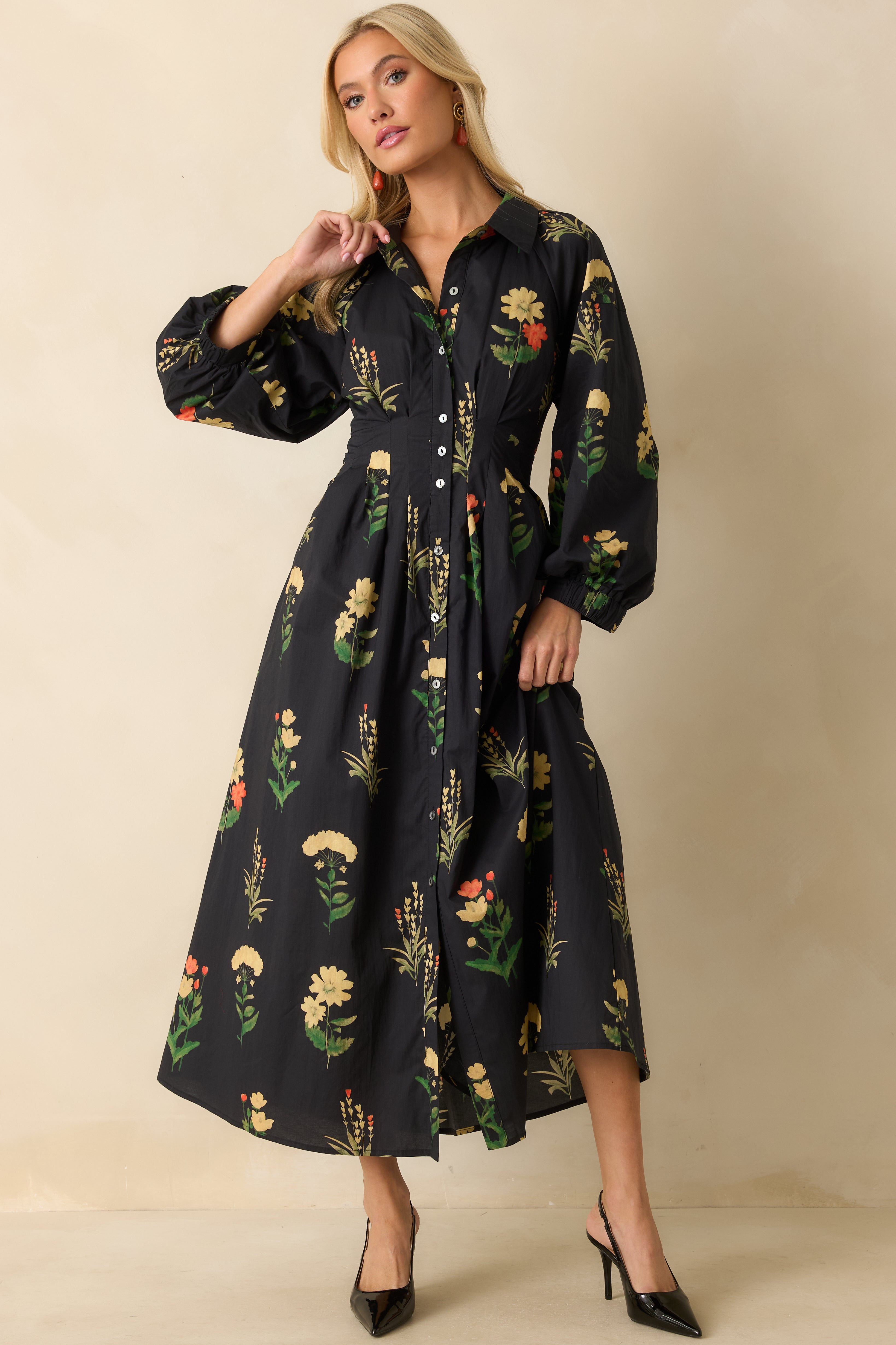 Floral black woven dress with collared neckline, button-front closure, and side pockets.