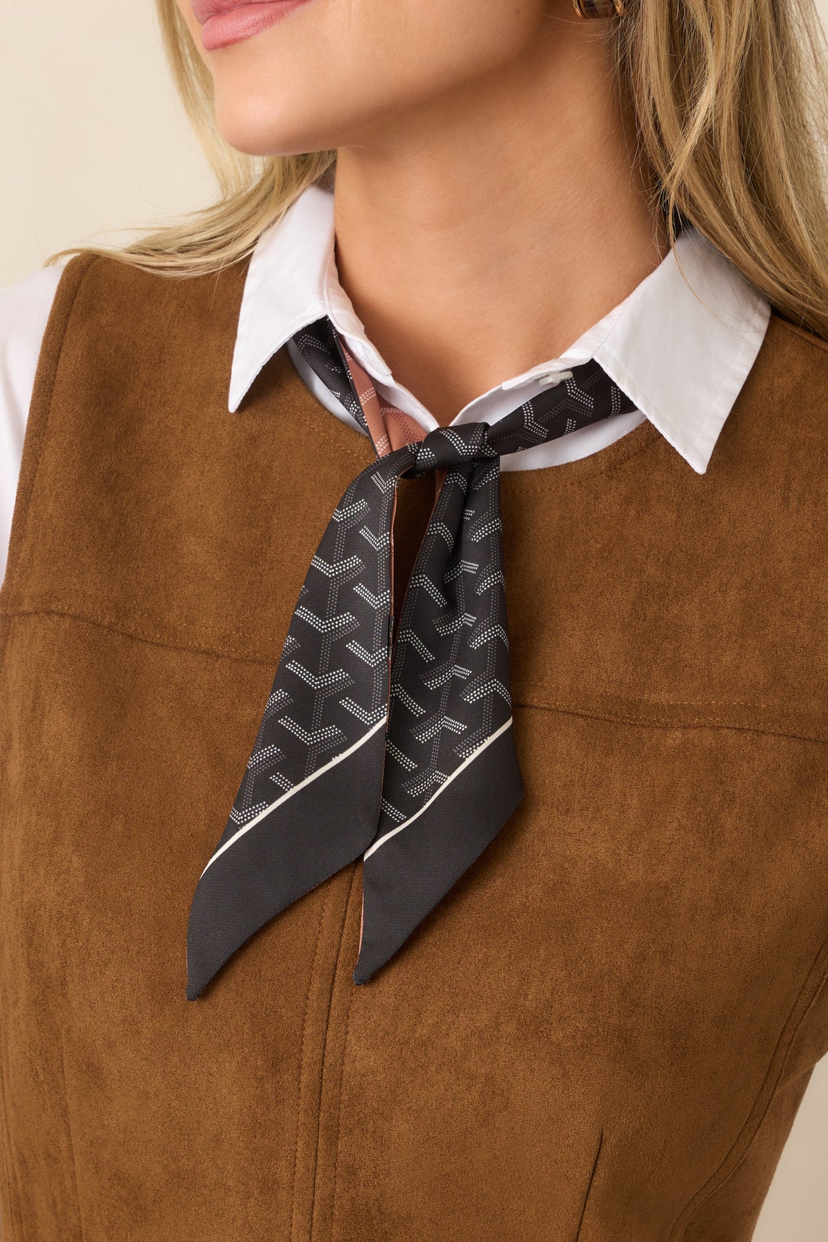 Slim black scarf featuring a subtle geometric print, contrast border, and elongated silhouette.