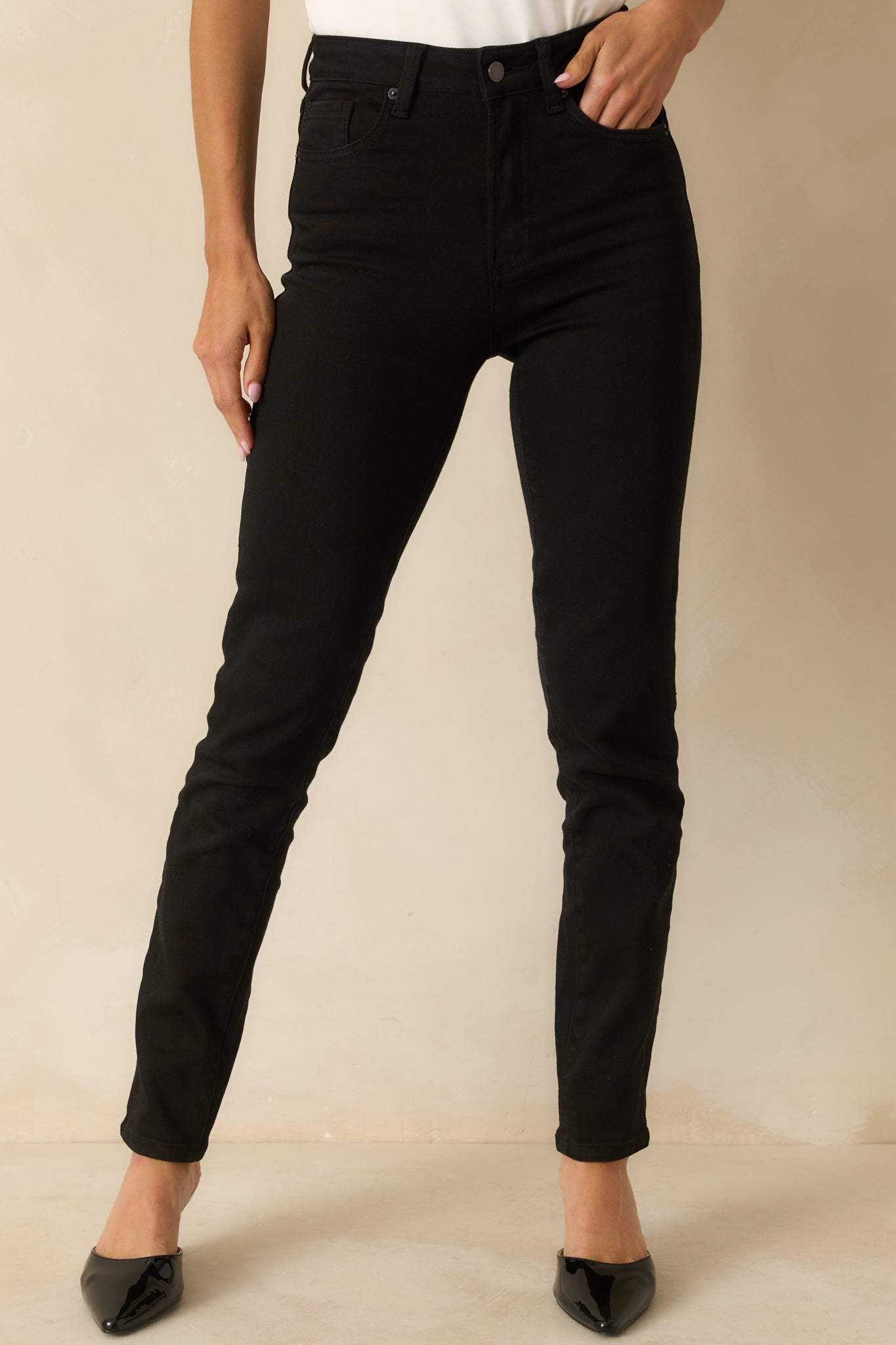 Black high-rise jeans styled with a five-pocket design and a flattering slim silhouette.