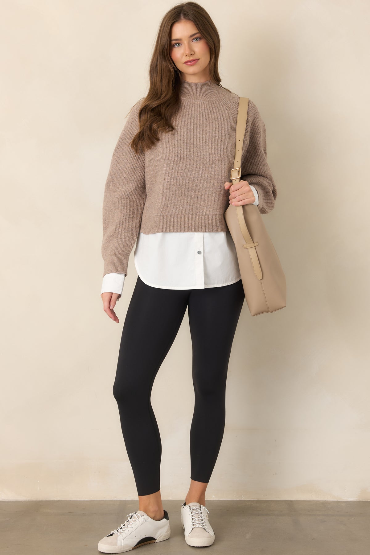 Sleek black leggings with a supportive contoured waistband, concealed pocket, and flattering 7/8 silhouette.
