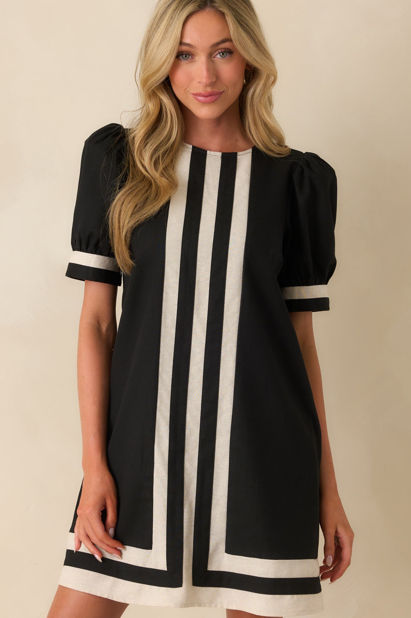 A cropped view focusing on the round neckline, center stripe detail, and the gathered shape of the short puff sleeves.