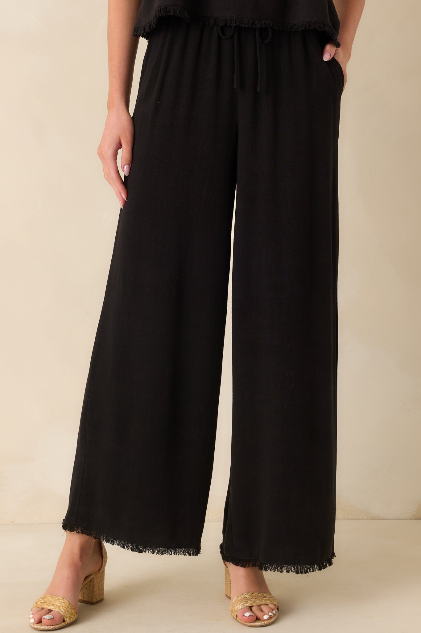 A cropped front view focusing on the waistband area, showing the elastic band and adjustable drawstring detail.