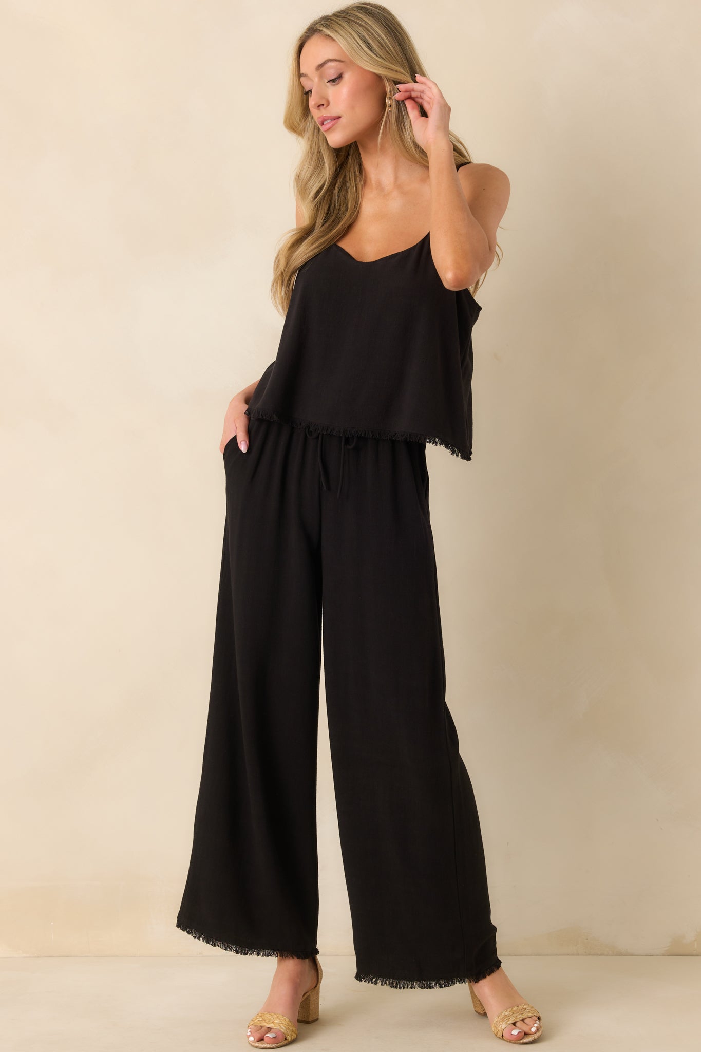 A full front view of the black pants showcasing the high rise fit, wide leg silhouette, and relaxed drape of the linen blend fabric.