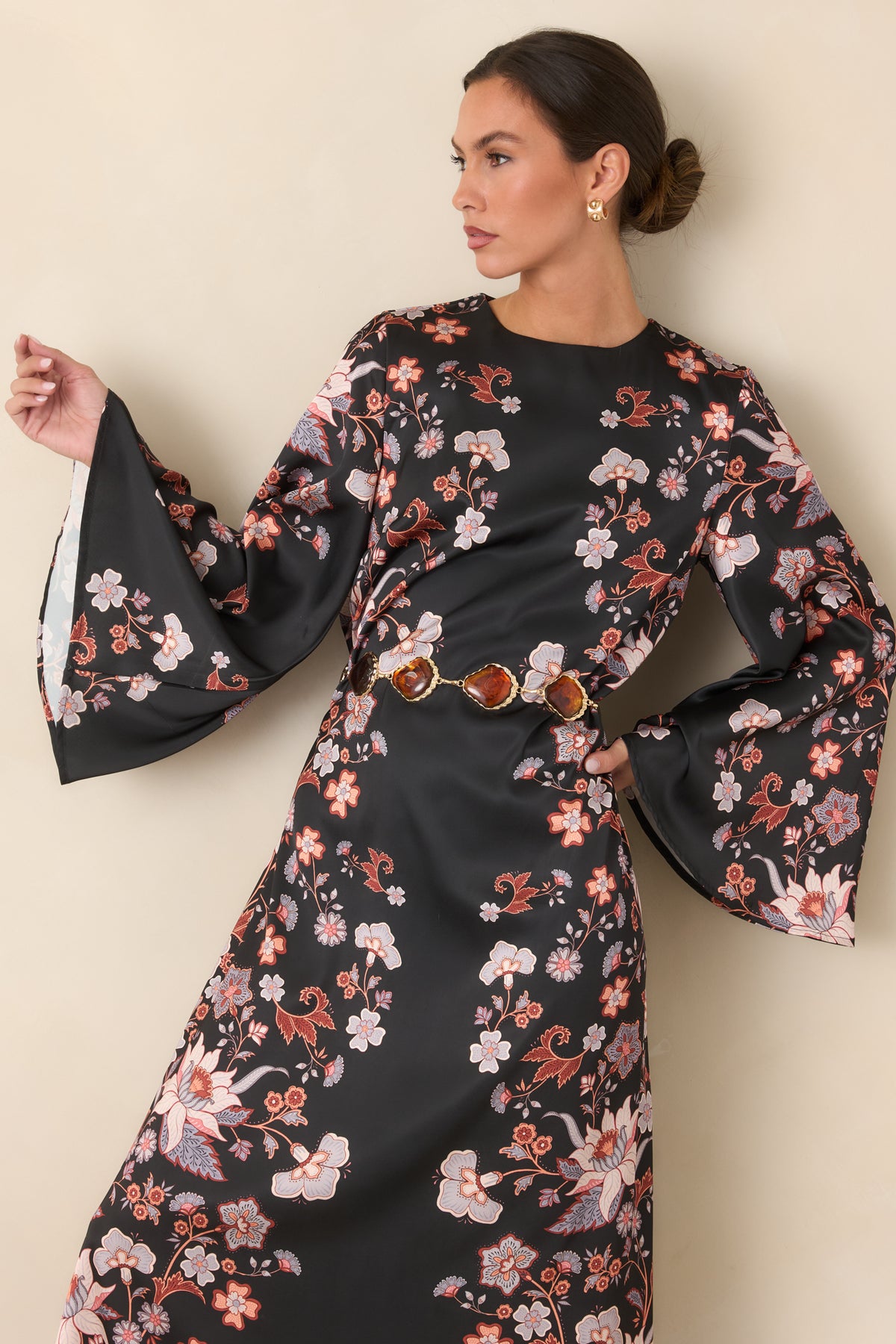 Lustrous black satin dress with a relaxed flowing silhouette and sweeping maxi hem.