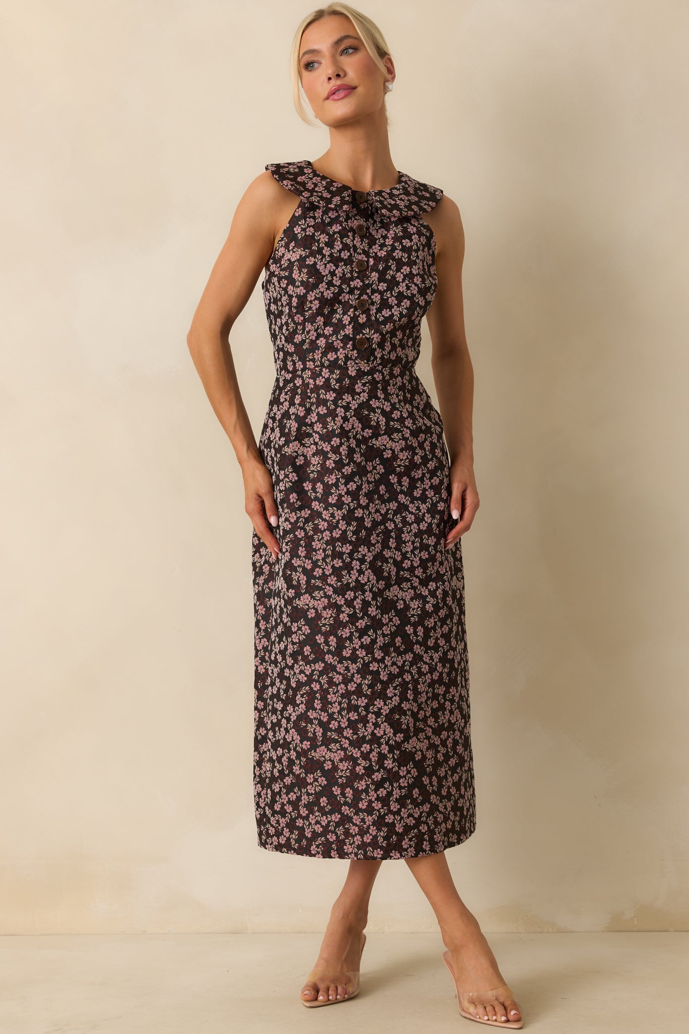 Black midi dress with pink floral jacquard, tailored bodice, and a sleek sleeveless silhouette.
