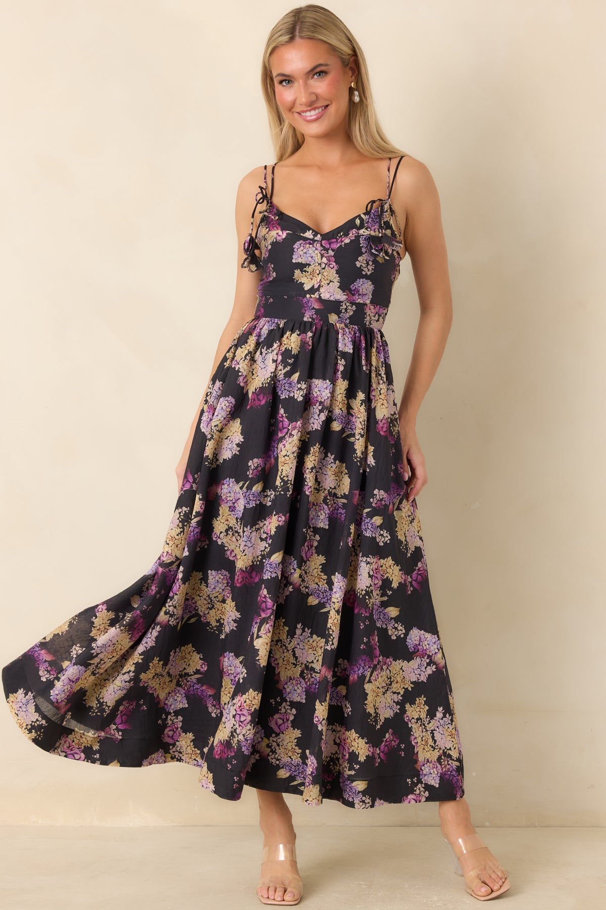 Black midi dress with delicate pink and lilac flowers, floral tie straps, and a softly gathered waist.