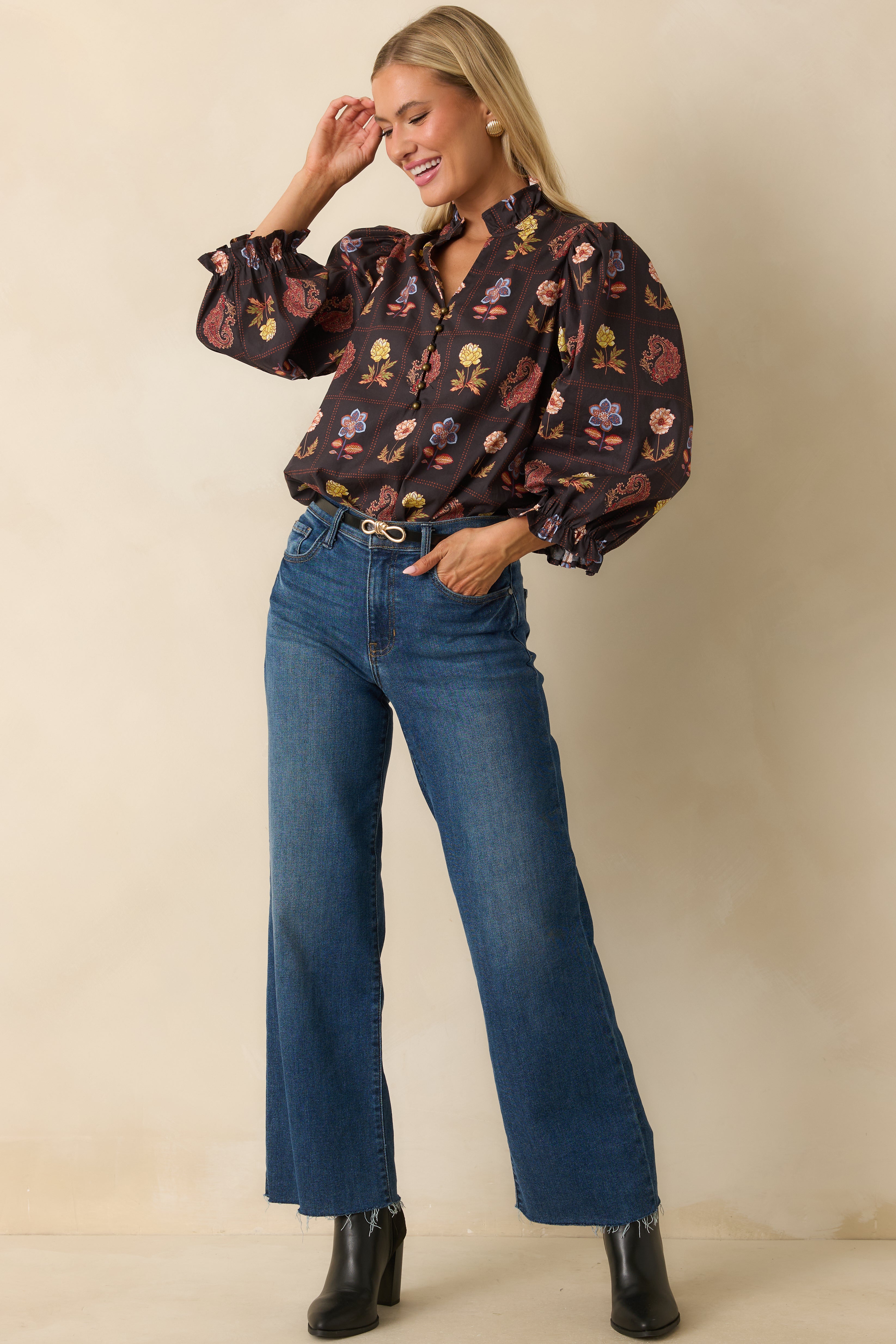 Black multi floral blouse with half-button closure, ruffled neckline, and airy fit.