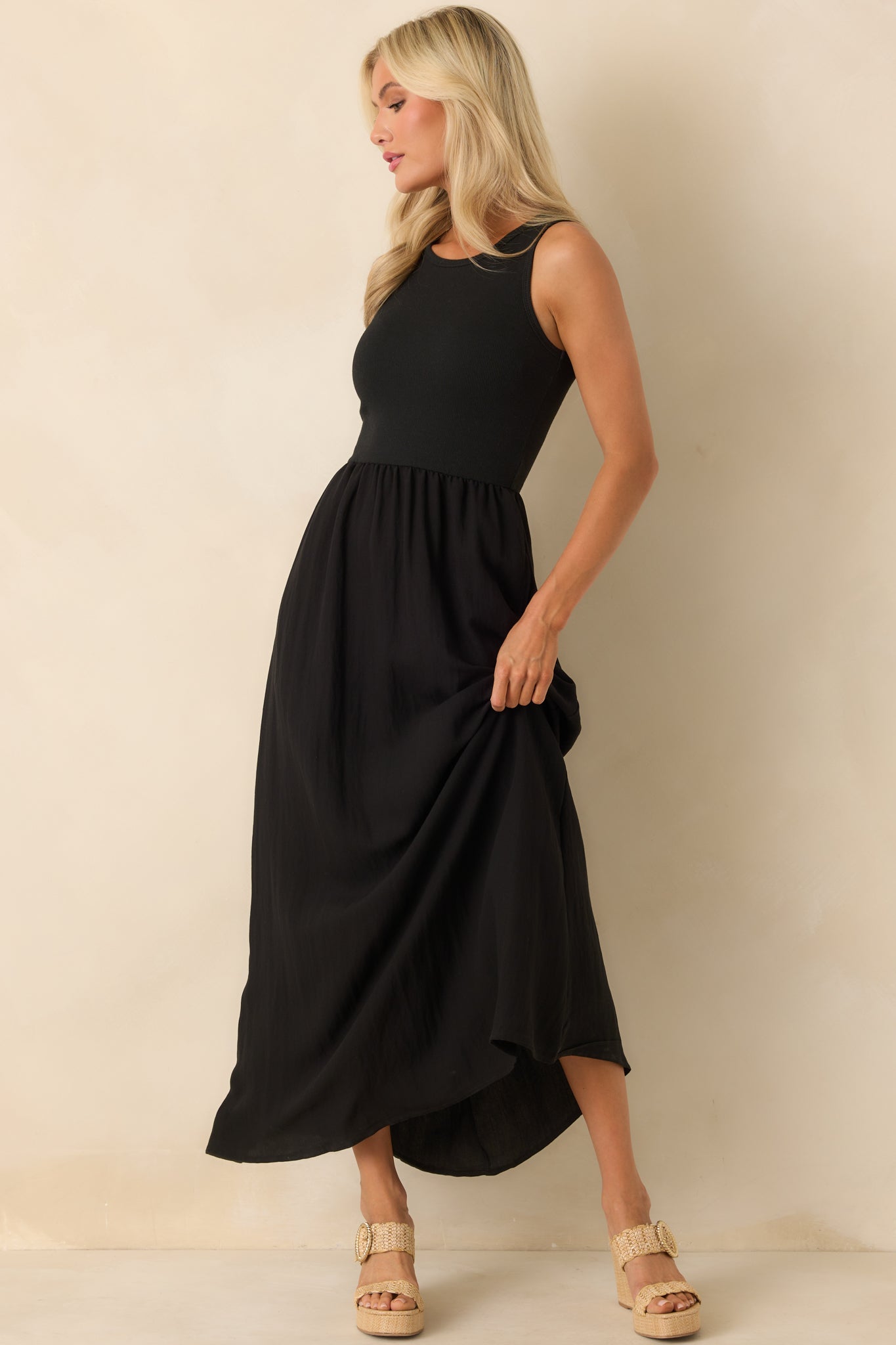 An angled full body image highlighting the contrast between the fitted bodice and the textured skirt.