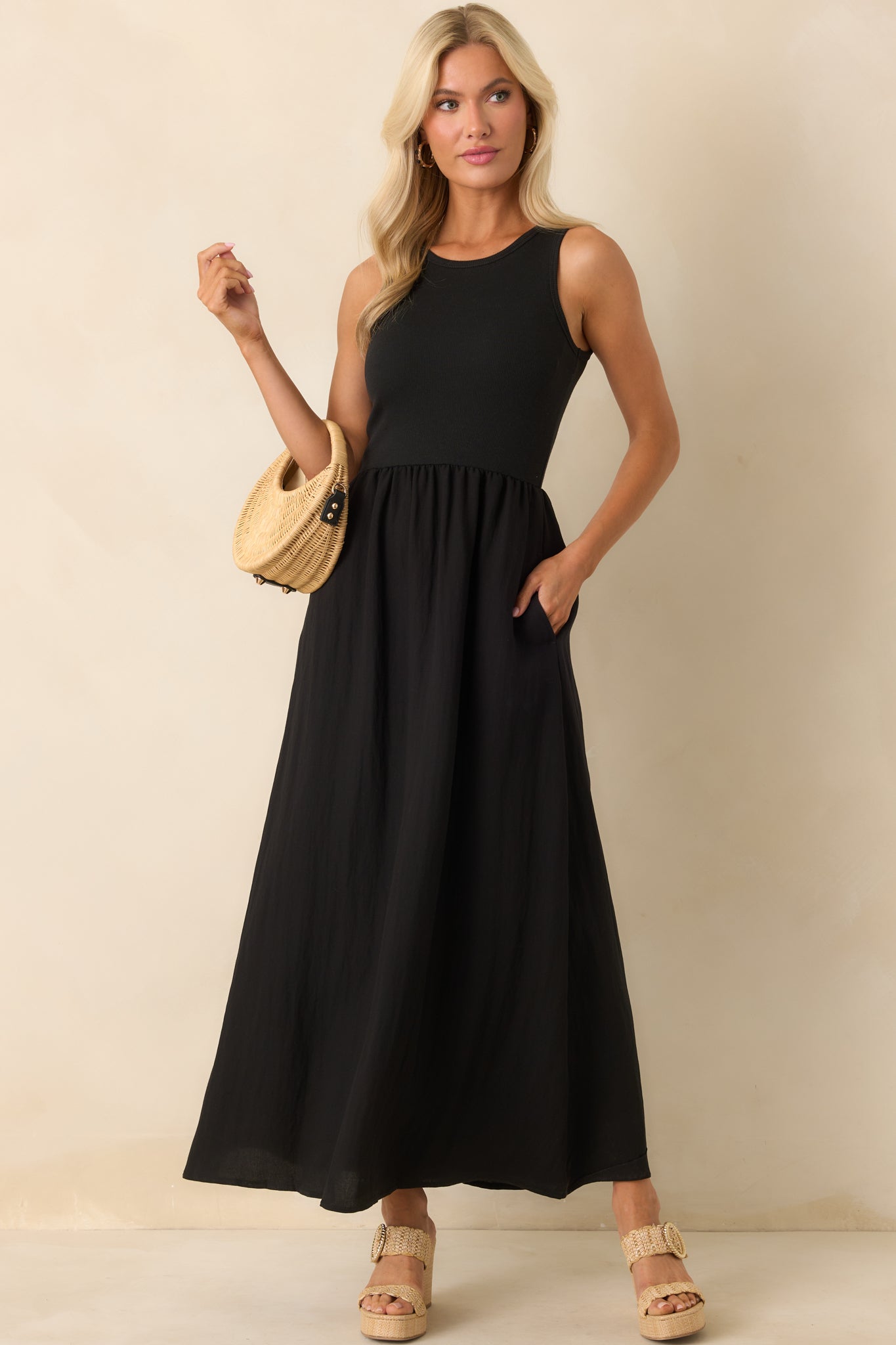 A full front view of the black midi dress showcasing the ribbed cotton bodice, crew neckline, and sleeveless design.