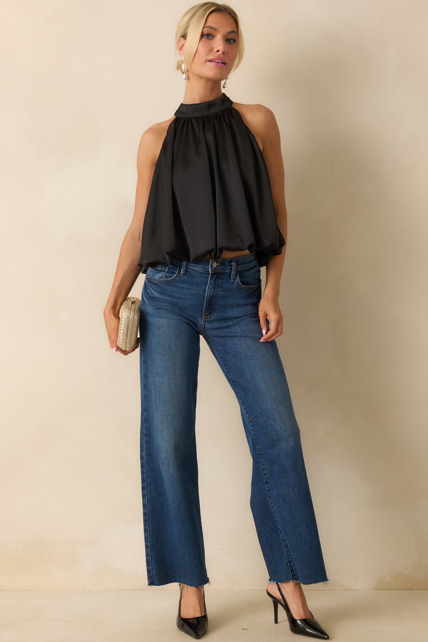 Black satin halter top showing its gathered high neckline and softly draped blouson silhouette.