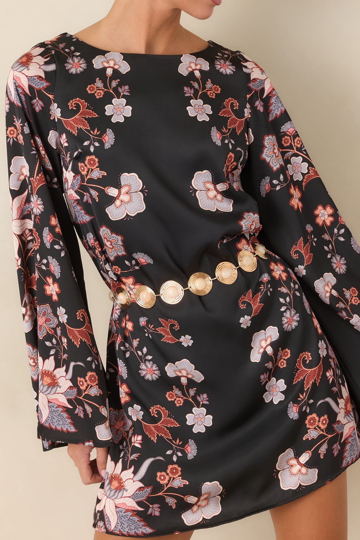 Close-up of the periwinkle, ivory, and rust floral print against the smooth black satin.