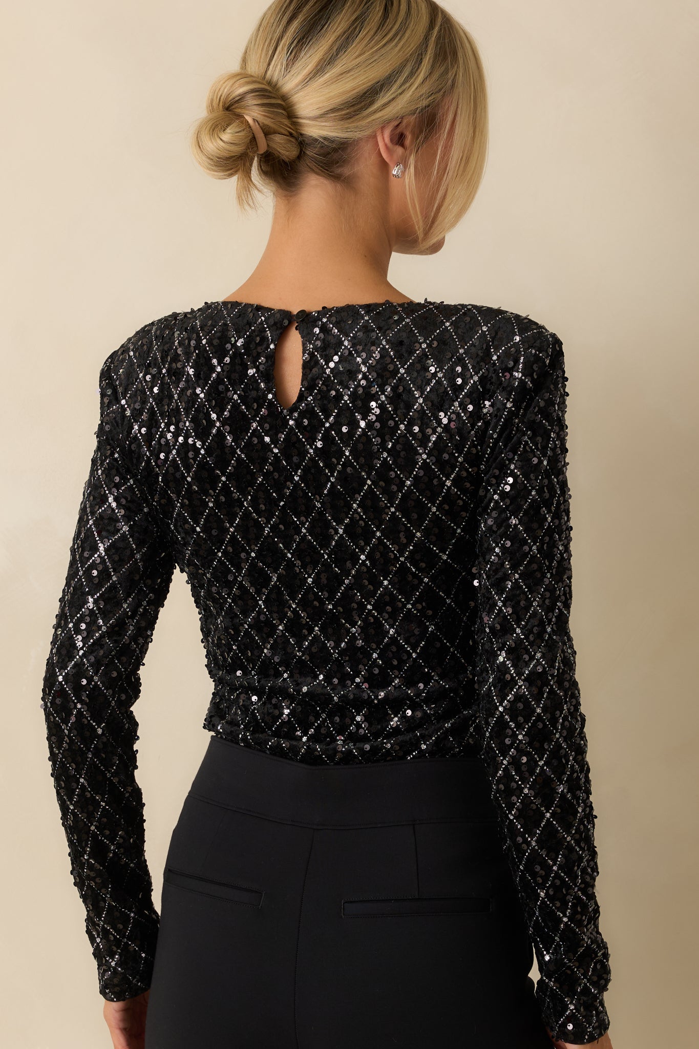 Rear view of the black sequin bodysuit showing the smooth, fitted silhouette and sequin coverage throughout.
