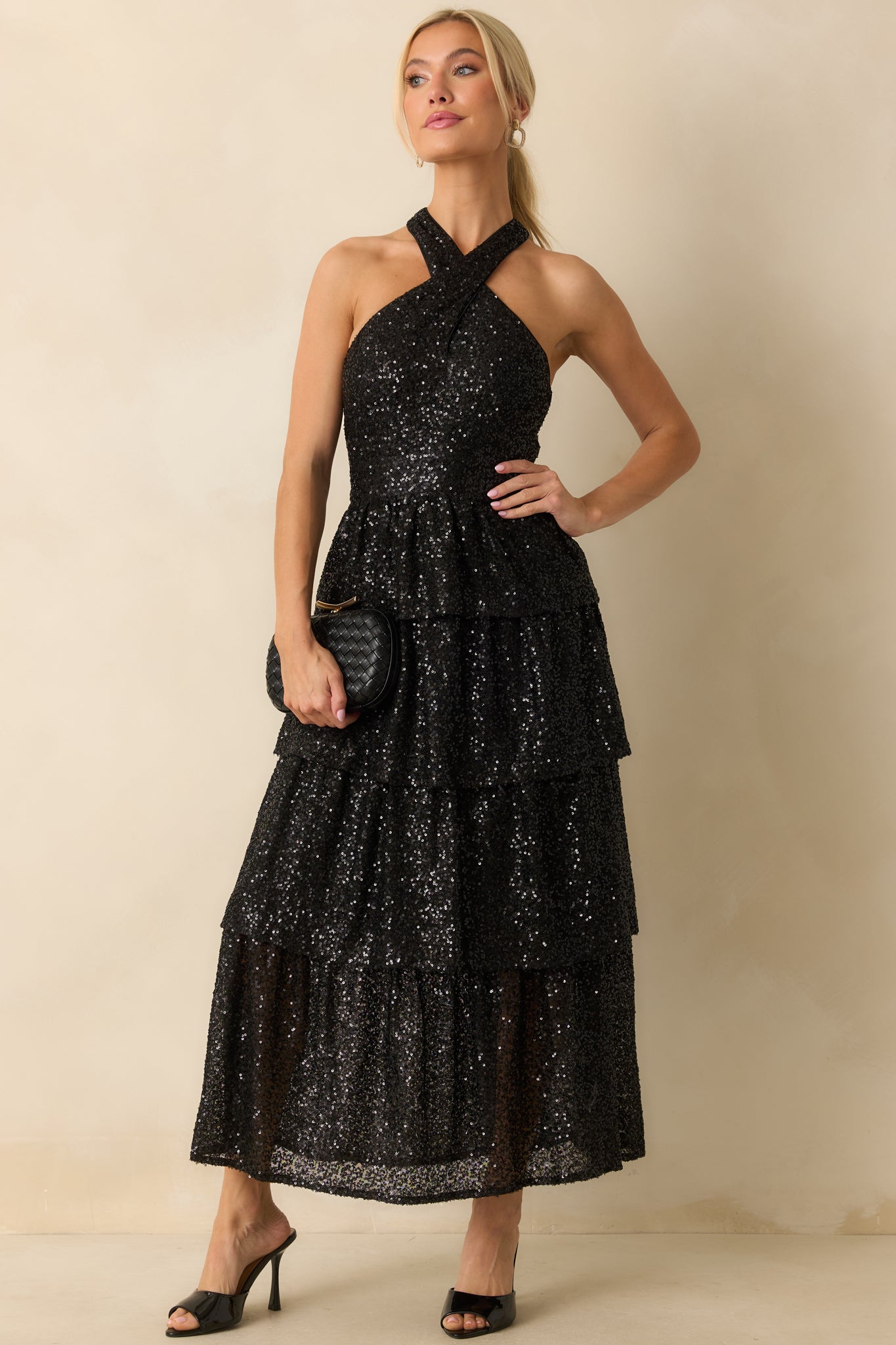 Long black maxi dress with sparkling sequins throughout and a tiered silhouette for a dramatic effect.