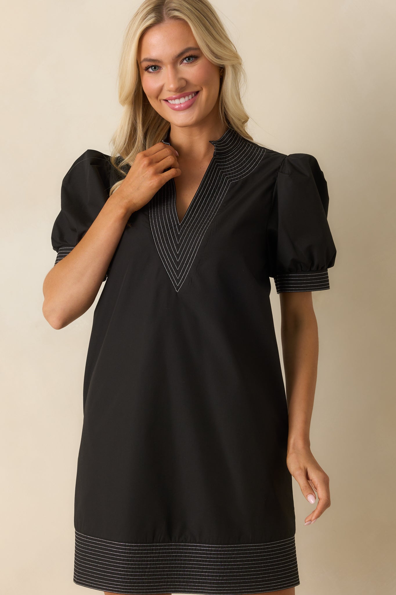 Skirt hemline trimmed with clean contrast stitching against black fabric.