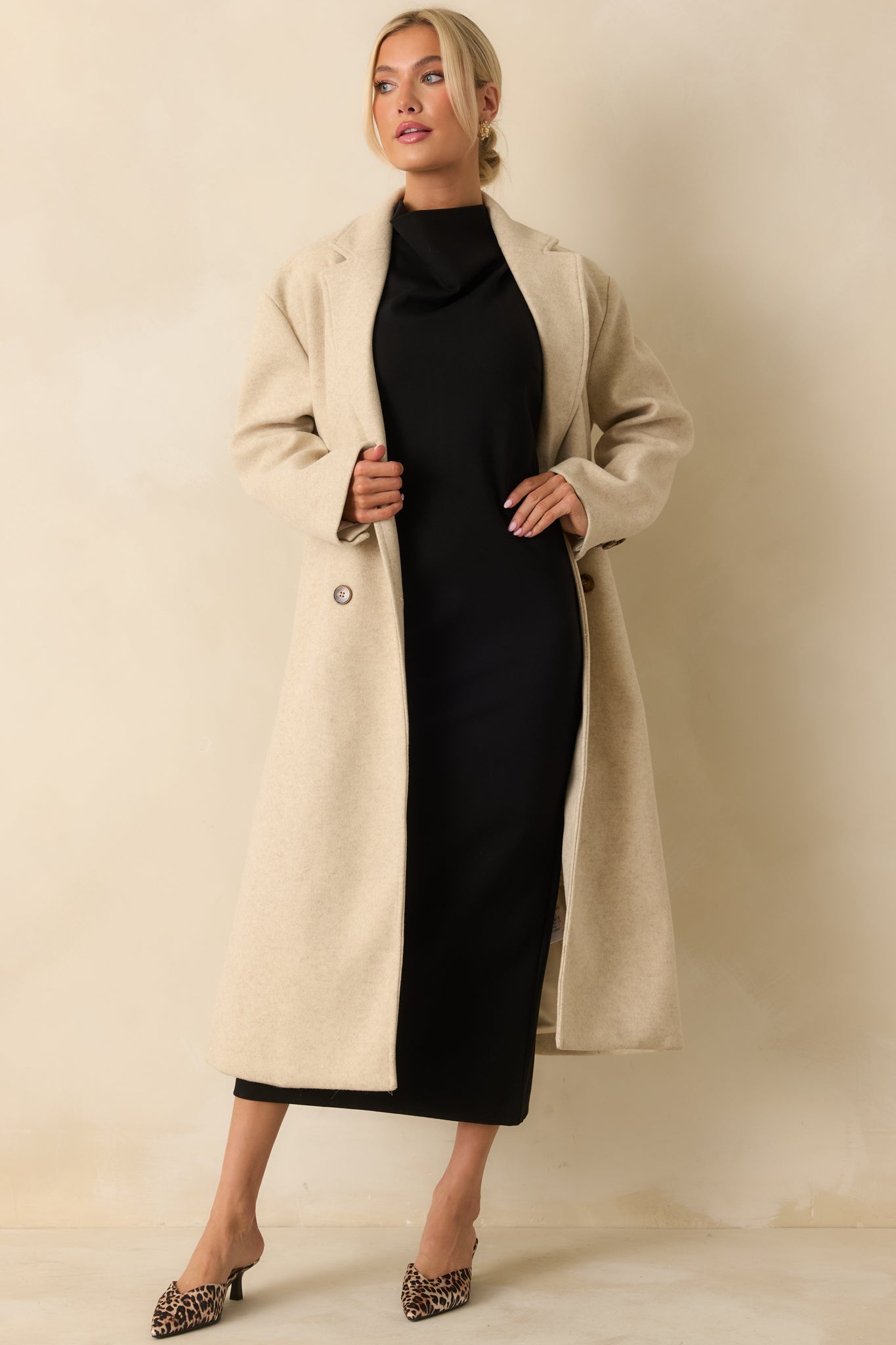 Black sleeveless midi dress with a bodycon fit, high neckline, and figure-flattering silhouette crafted from stretchy ponte fabric.