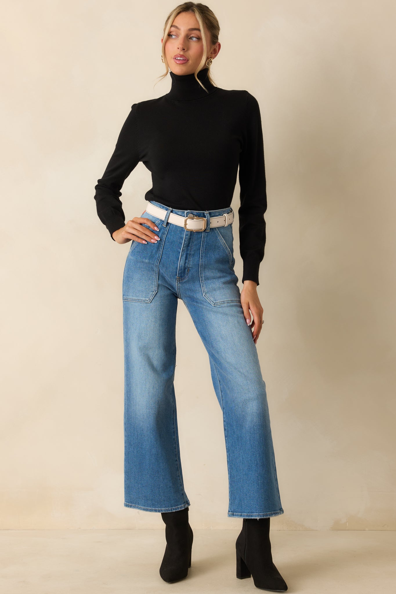 Black turtleneck sweater highlighting its smooth knit texture and timeless, comfortable design.