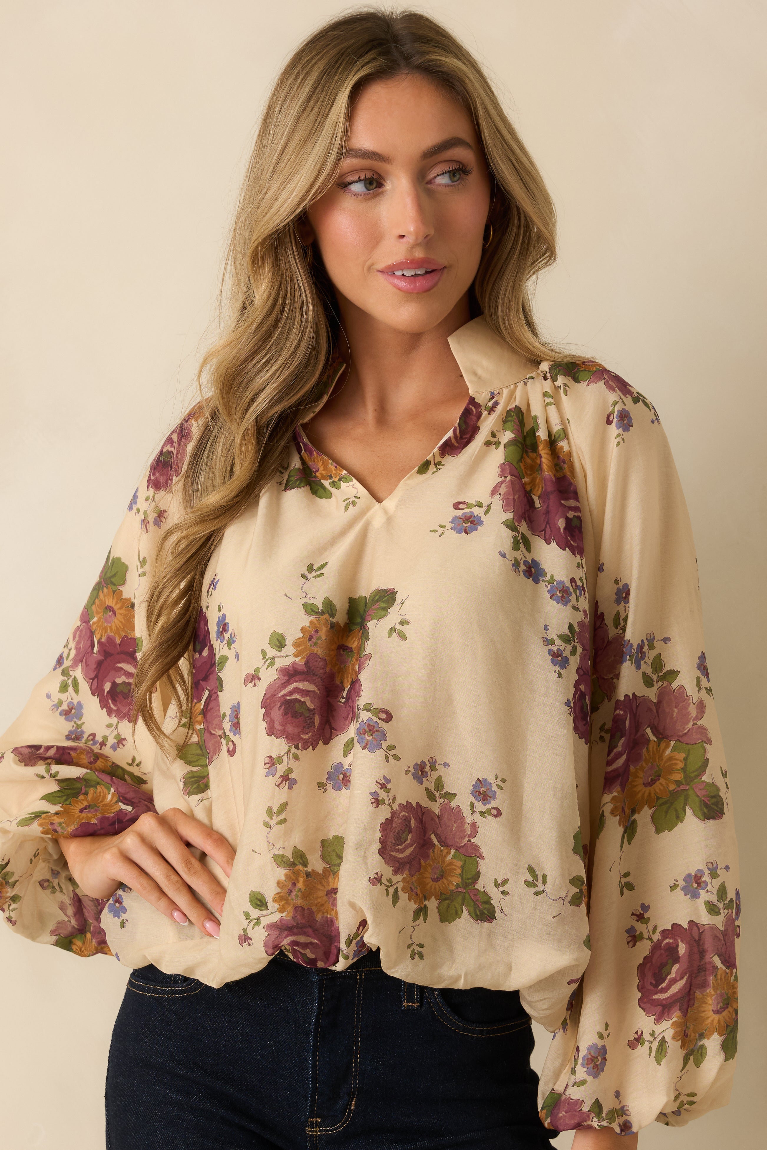 View focusing on the blouson sleeves and delicate floral pattern.