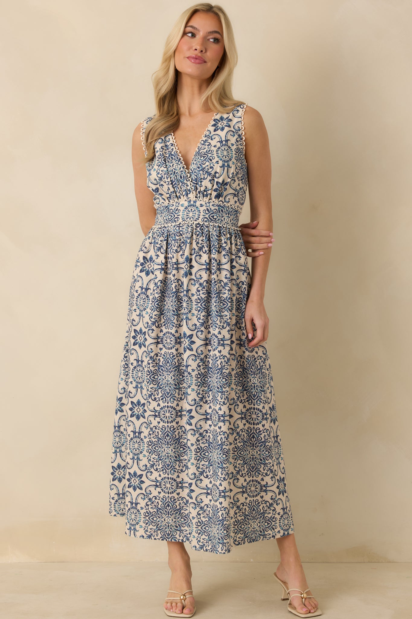 Blue and ivory midi dress showcasing sleeveless cut, adjustable self-tie back, and flowing skirt.