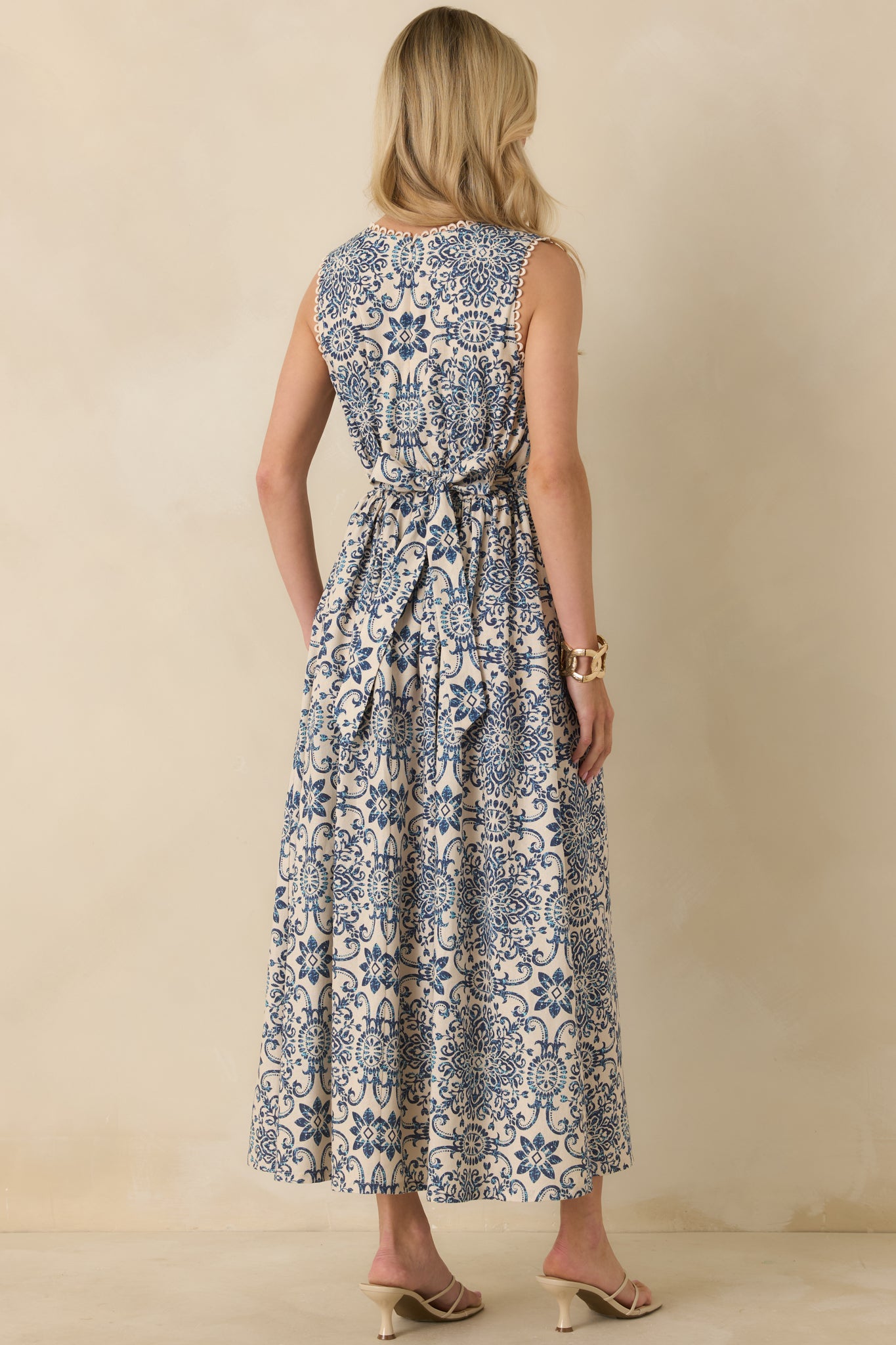Back view of blue and ivory tile-print midi dress featuring adjustable self-tie closure and full A-line skirt.
