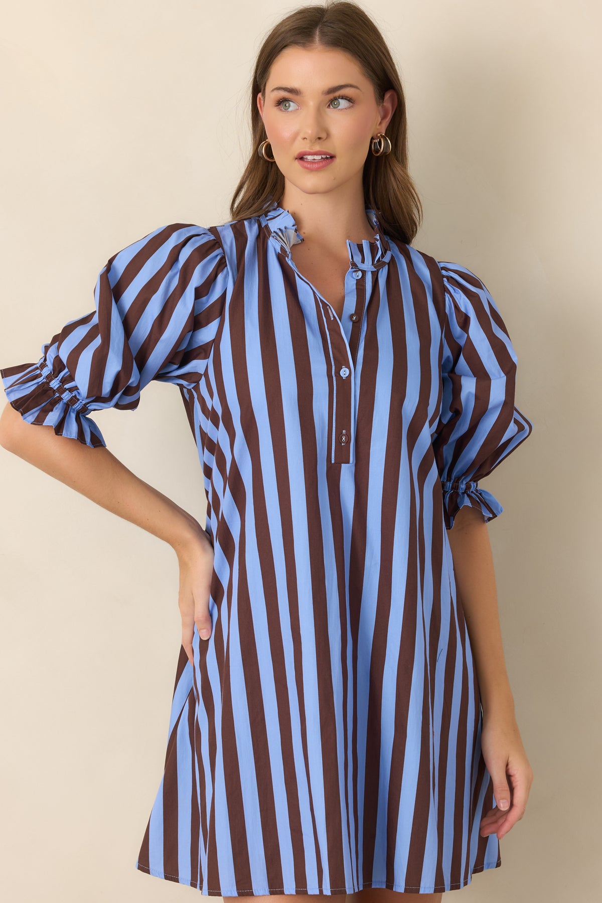 Crisp striped cotton dress featuring voluminous puff sleeves, delicate ruffle cuffs, and softly gathered fabric through the upper bodice.
