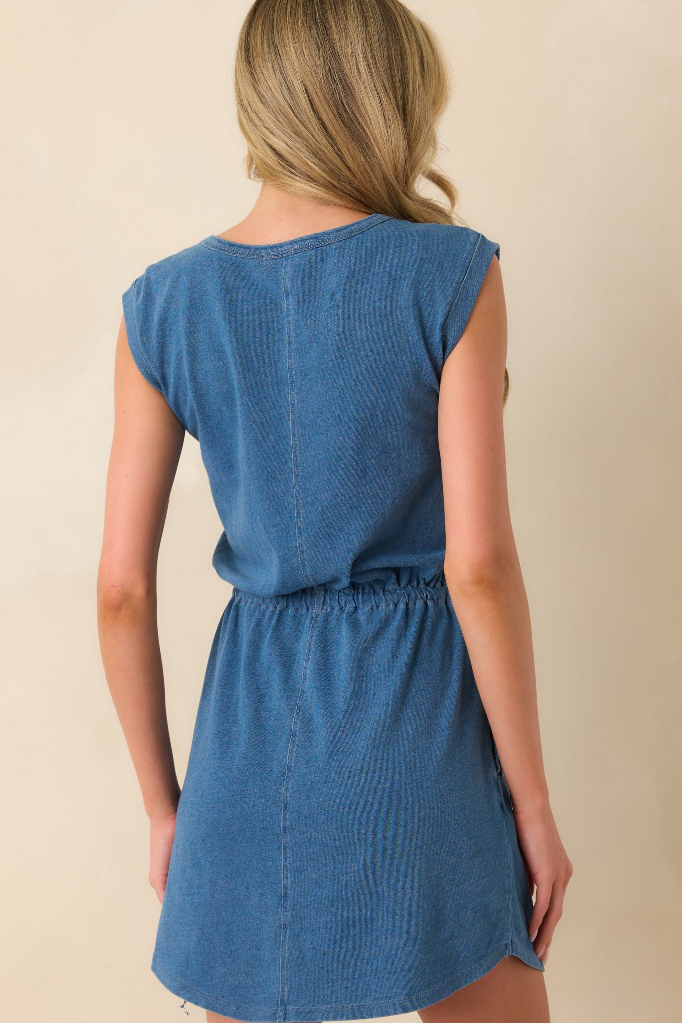 A view from behind showing the center seam running down the back, the shape of the cap sleeves, and the soft drape of the jersey fabric