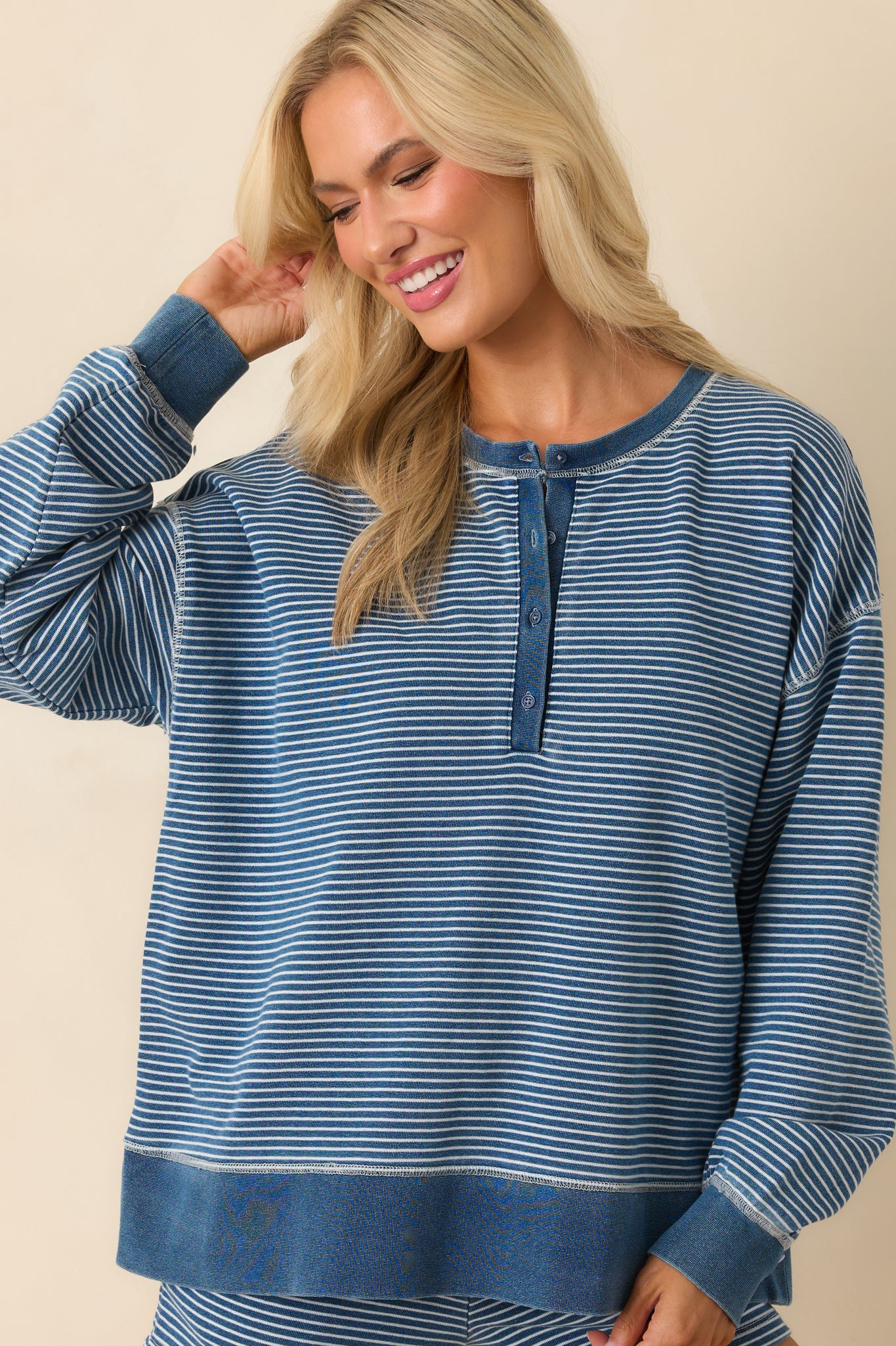 Cropped front image focusing on the functional quarter button placket and ribbed collar detail.