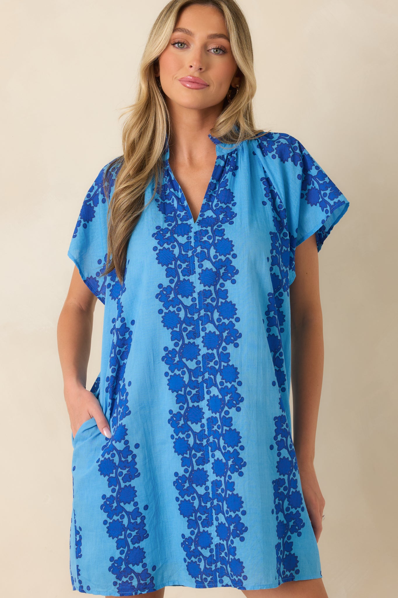 Blue mini dress highlighting the floral pattern and breathable cotton construction.