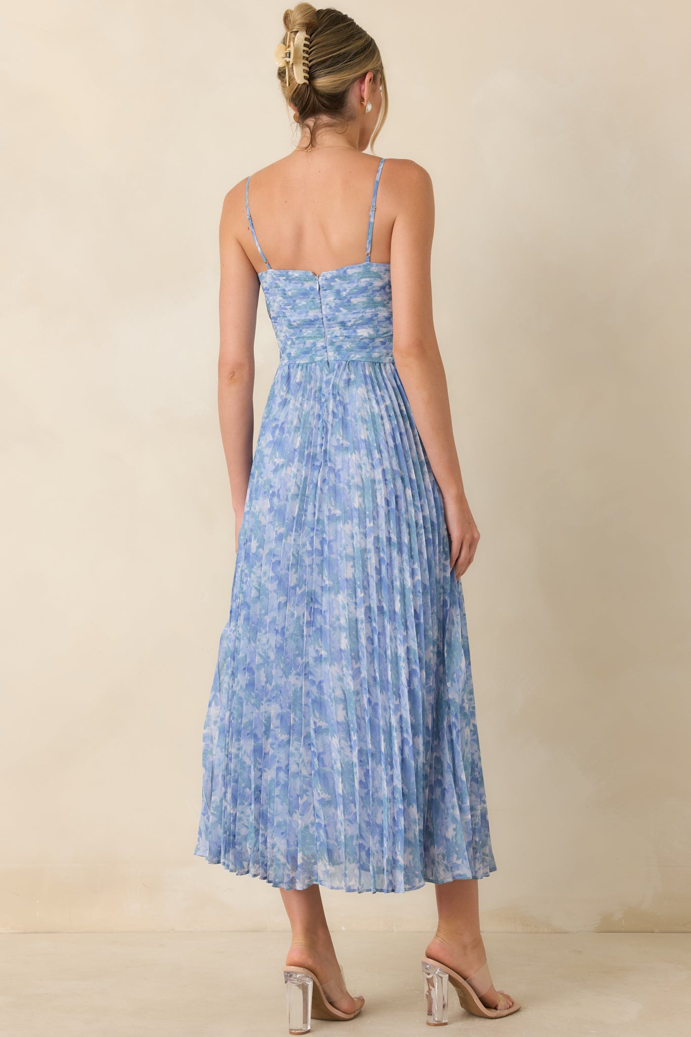 Back view of the floral maxi dress featuring adjustable spaghetti straps and a concealed zipper closure.