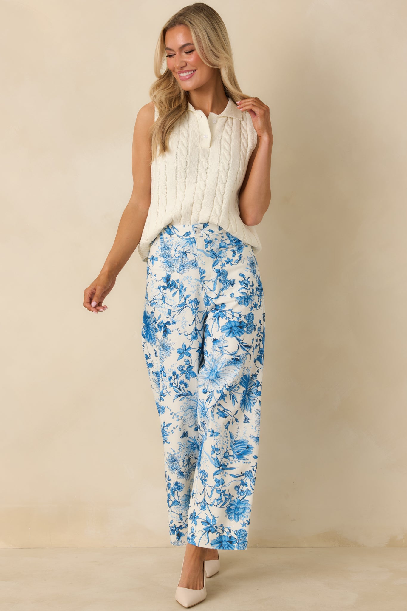 Blue floral print cotton pants with a high-rise waist, straight wide-leg silhouette, and front button closure.