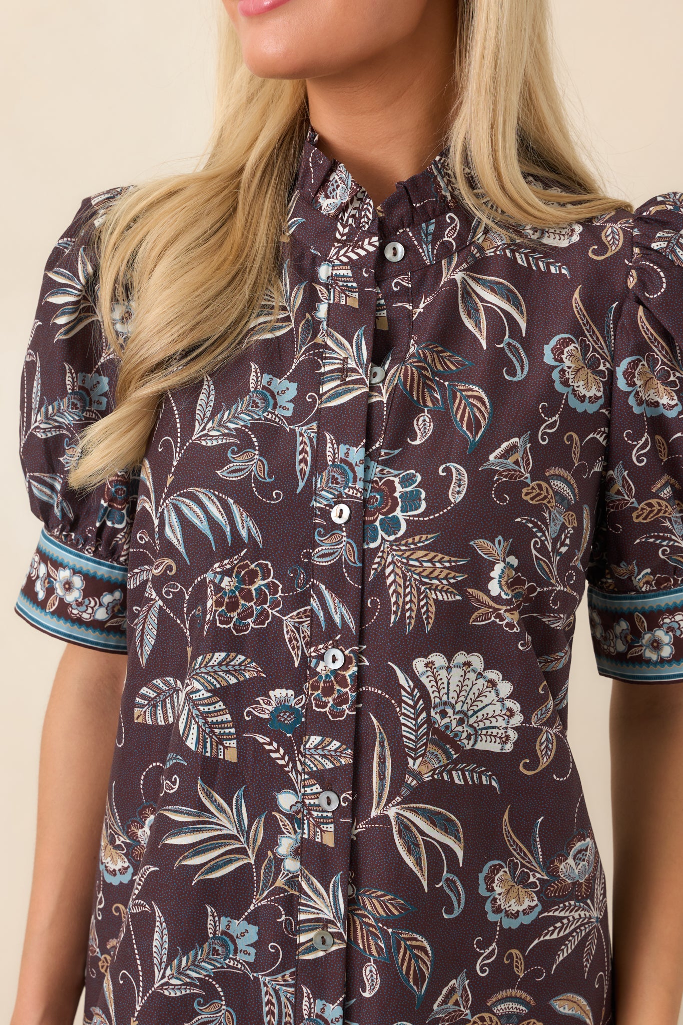 Close-up of the dress highlighting its intricate botanical floral print, blue and ivory accents, and decorative border detailing.