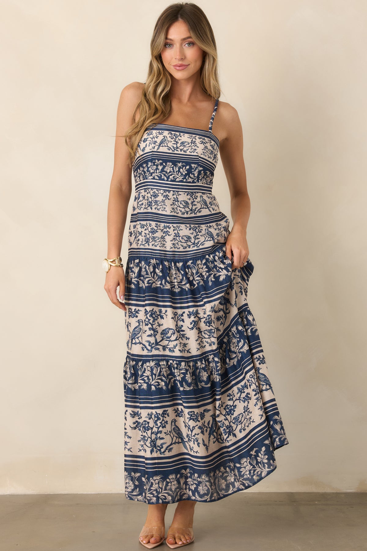 Deep blue and ivory stripes contrast with floral and bird motifs for a distinctive patterned finish.