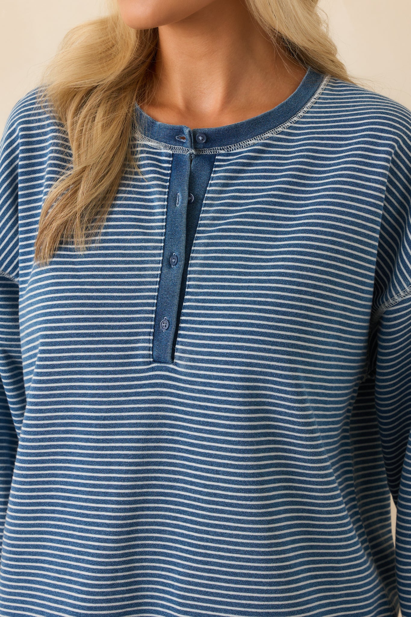 Zoomed-in detail of the ribbed cuff and sleeve fabric texture, showcasing stitching and stripe definition.