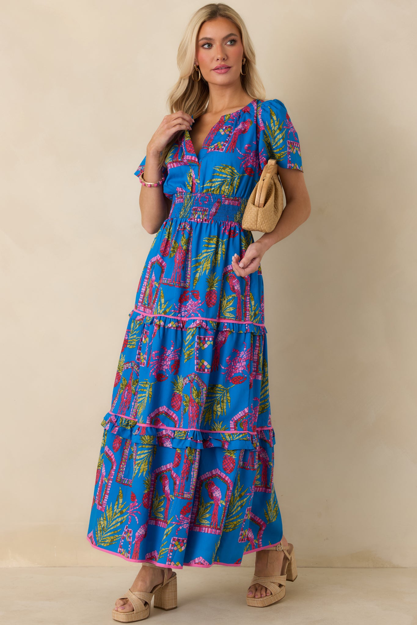 Blue maxi dress showcasing a vibrant print, subtly gathered puff sleeves, and a defined waist.