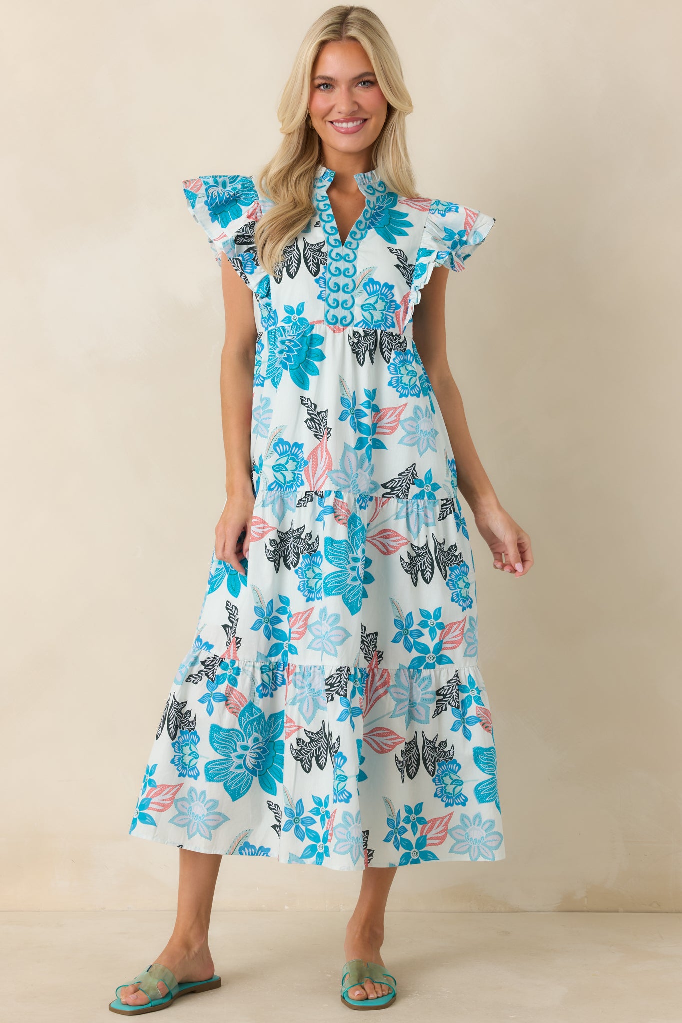 Blue multi print midi dress with embroidered neckline detailing, flutter sleeves, and a comfortable relaxed fit.