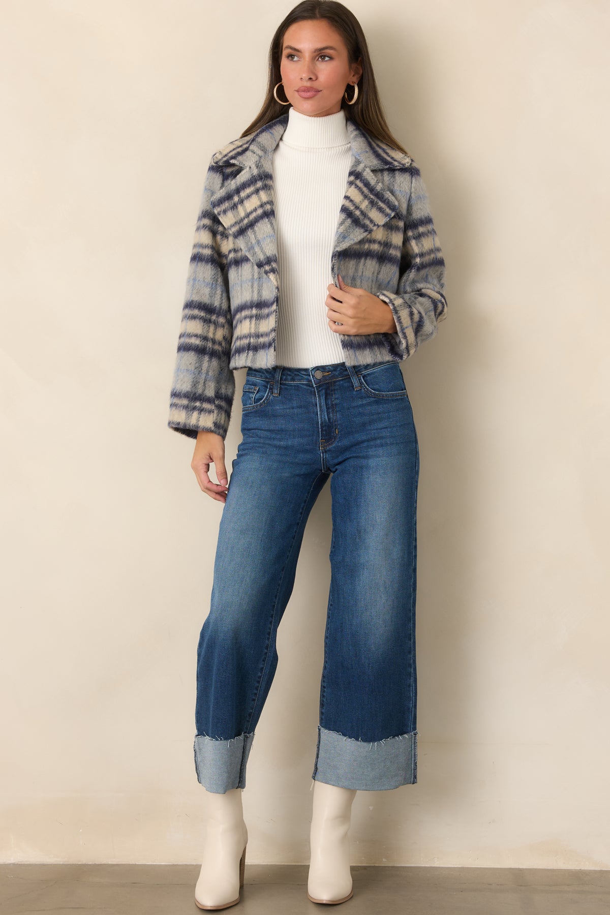 Blue, navy, and ivory plaid jacket with a cropped, boxy silhouette, oversized notched lapels, and relaxed long sleeves.