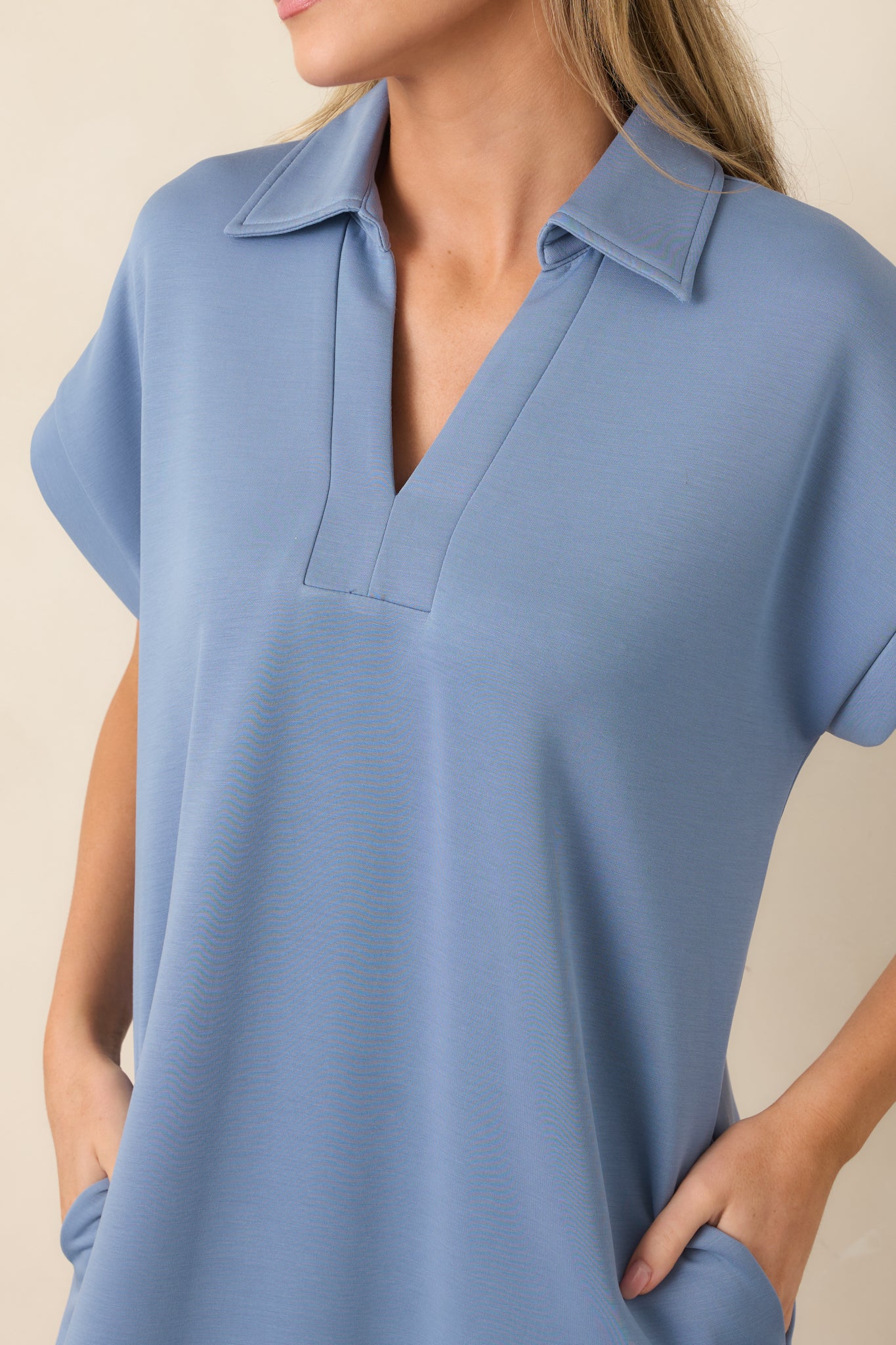 Close-up of the blue midi dress highlighting the collared notch V-neckline and buttery soft fabric texture.