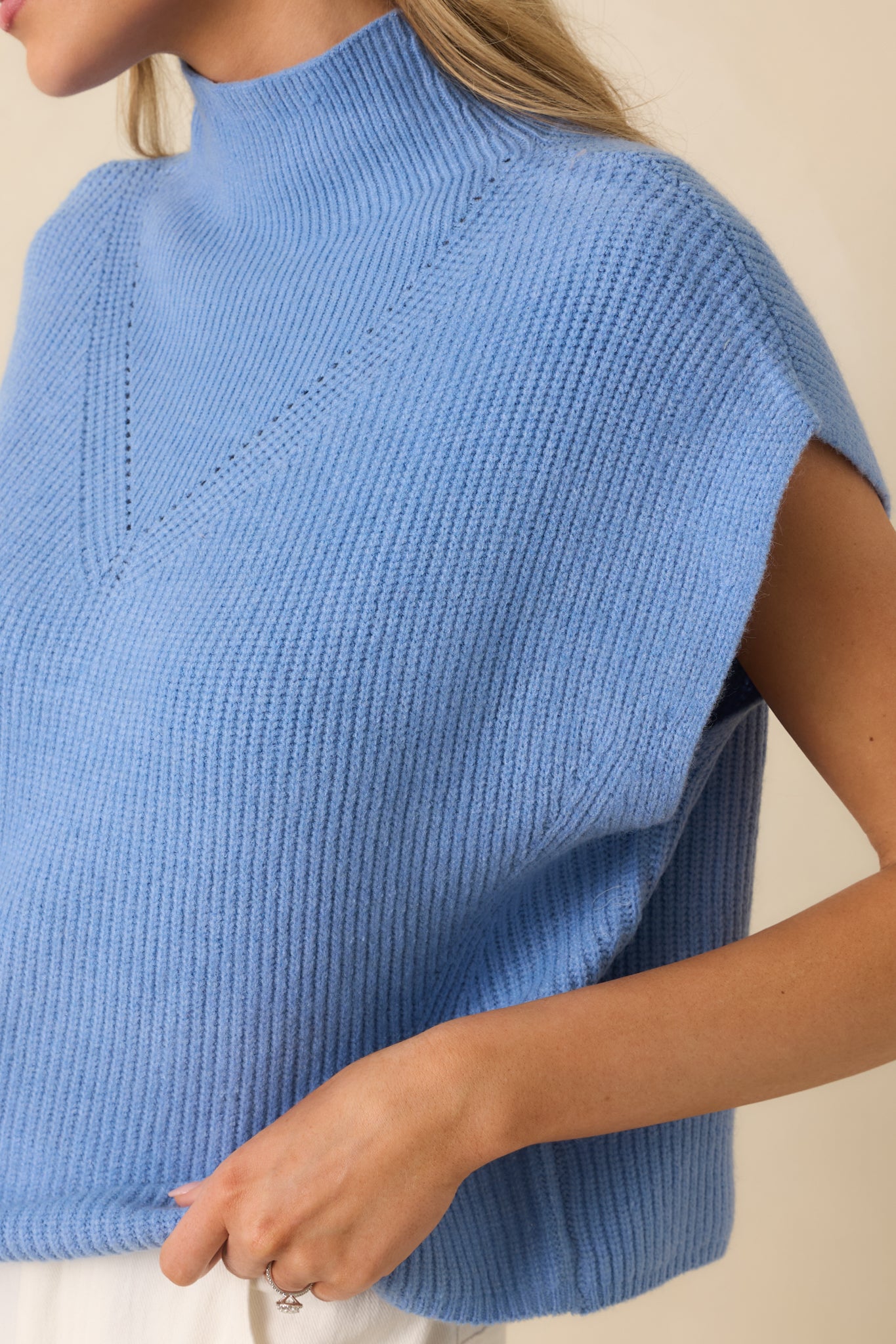Tight view of the ribbed knit fabric showing subtle chest detailing and smooth, even stitching in blue.