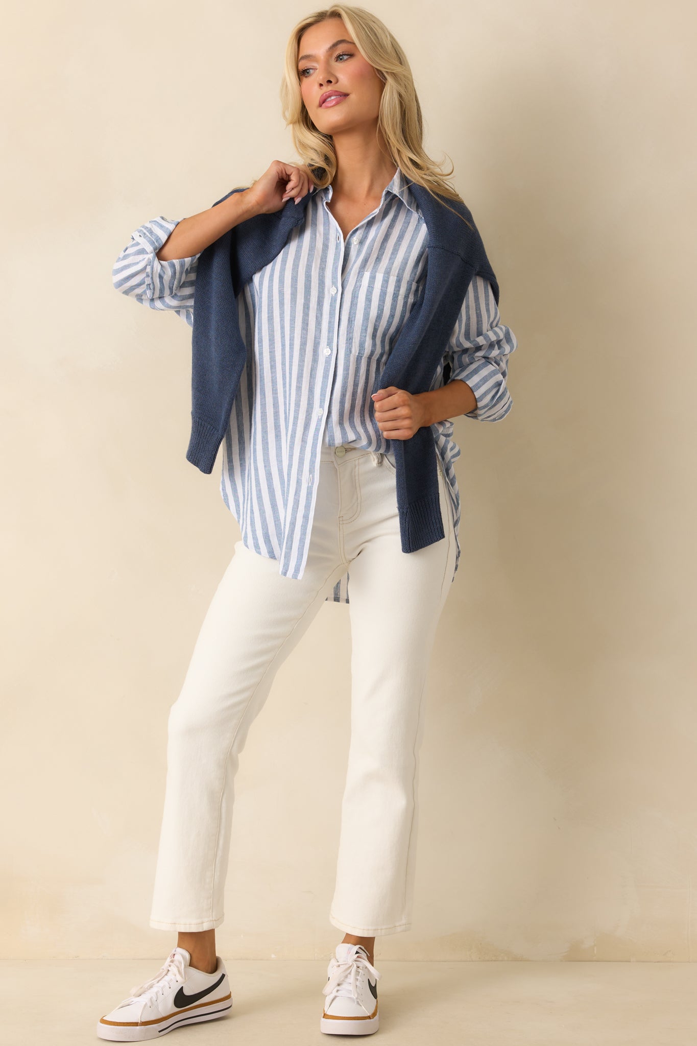 Blue stripe button-front top shown front facing, highlighting the collared neckline and long sleeves.