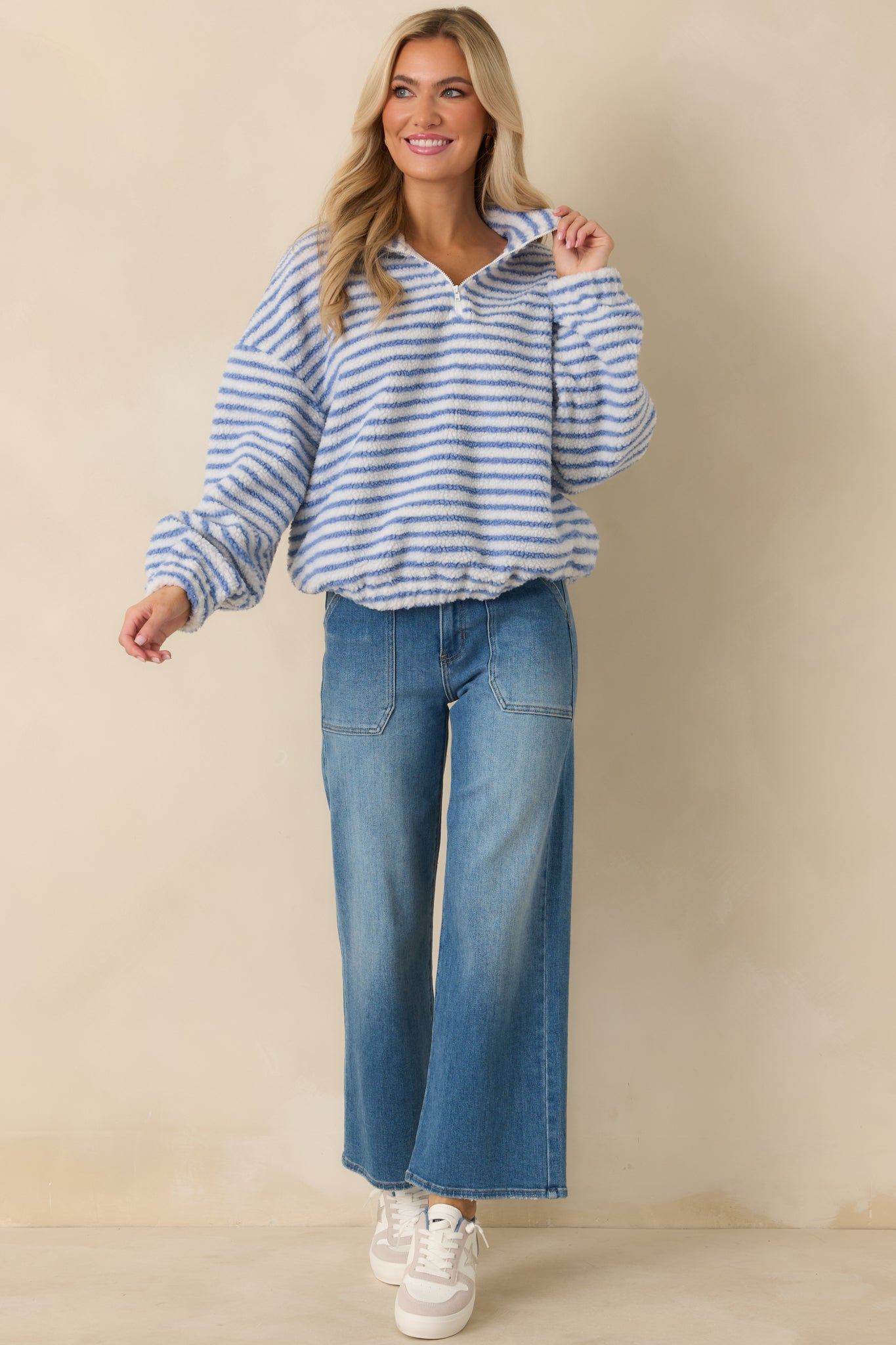 Blue stripe bouclé knit pullover with quarter-zip neckline and relaxed fit, shown front-facing with drop shoulders.