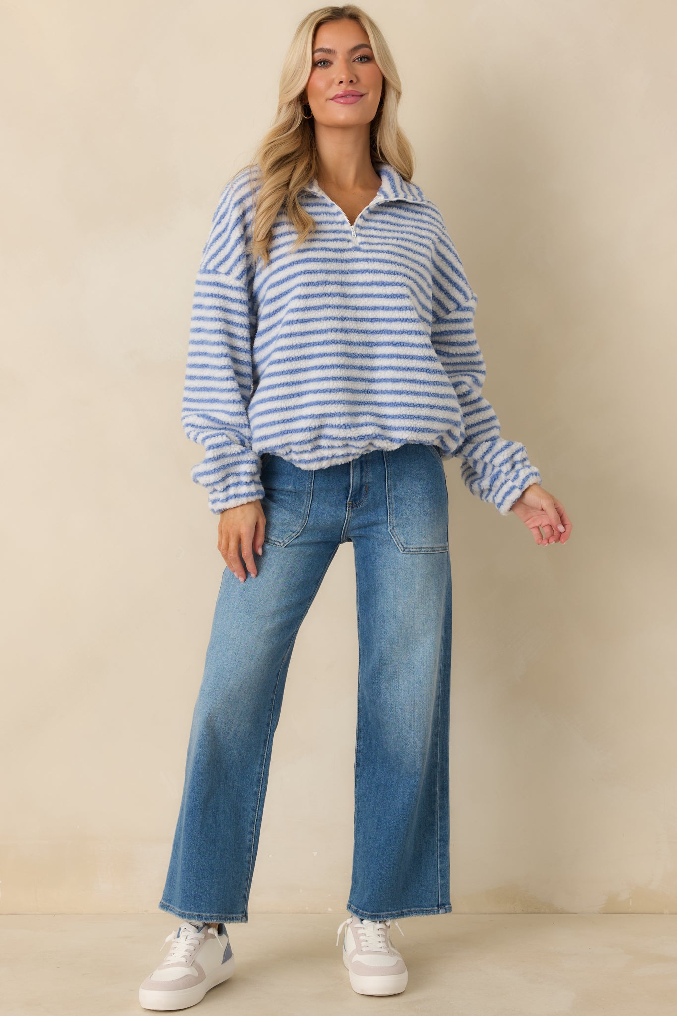 Blue striped knit pullover shown fully front-facing, featuring drop shoulders and soft textured bouclé fabric.