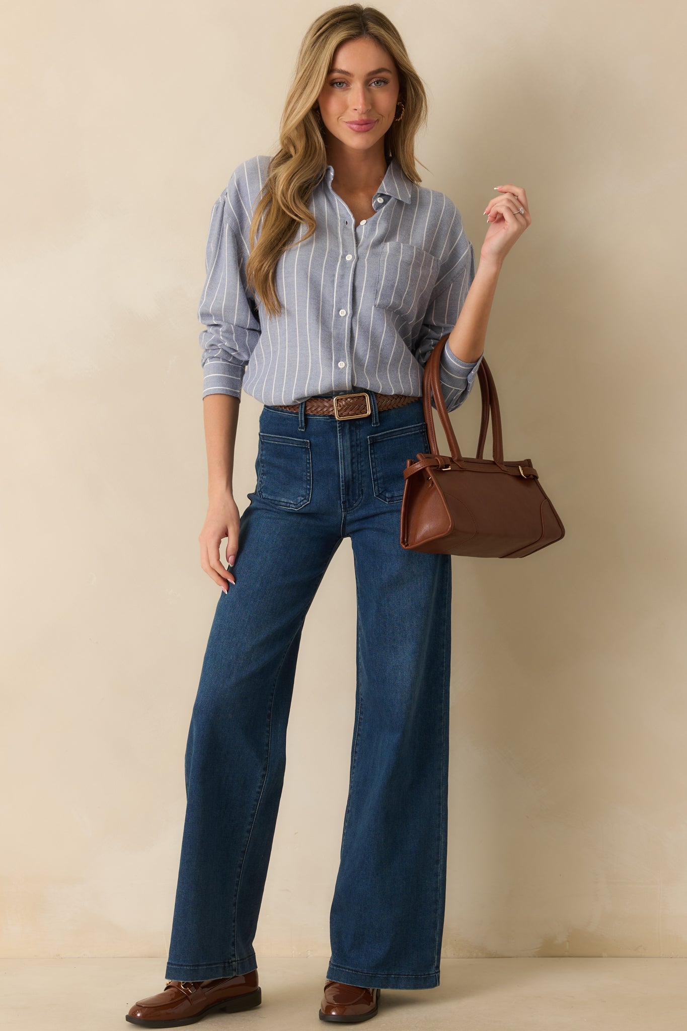 Front view of lightweight knit shirt in blue stripes, featuring long sleeves with buttoned cuffs and button-front closure.