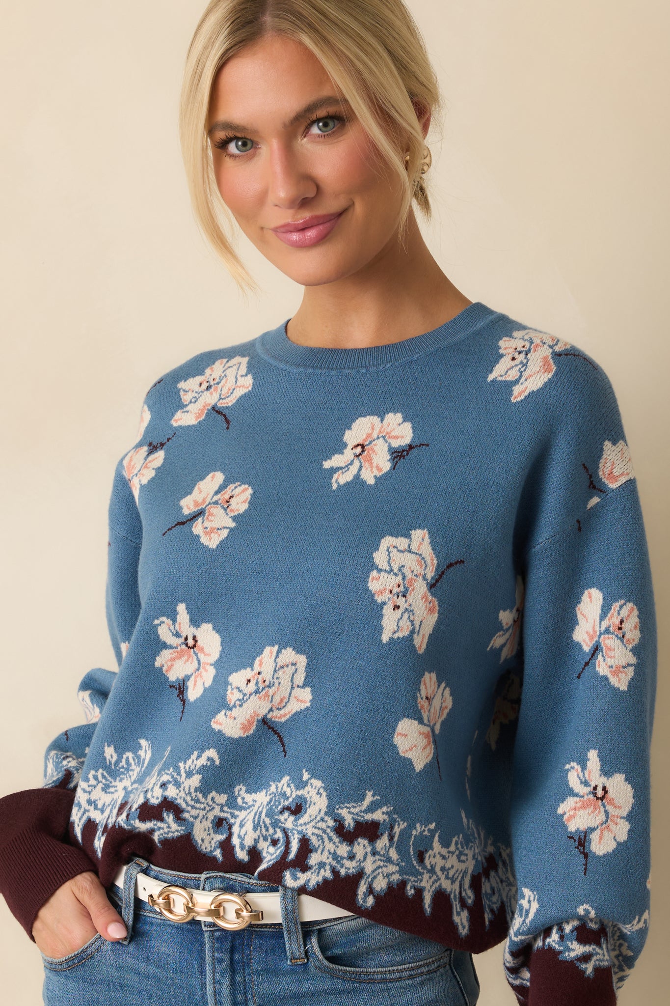 Cropped image highlighting the ornate border design and brown contrast hem.