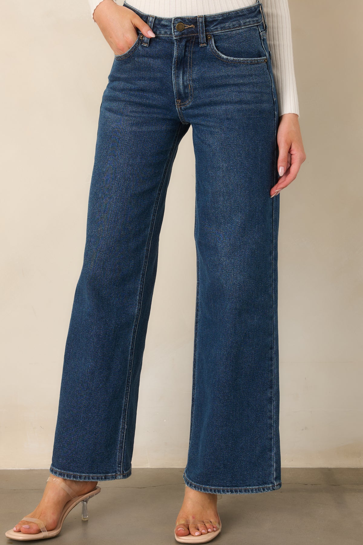 Blue wide leg pants showcase traditional five-pocket styling and a softly faded denim finish.