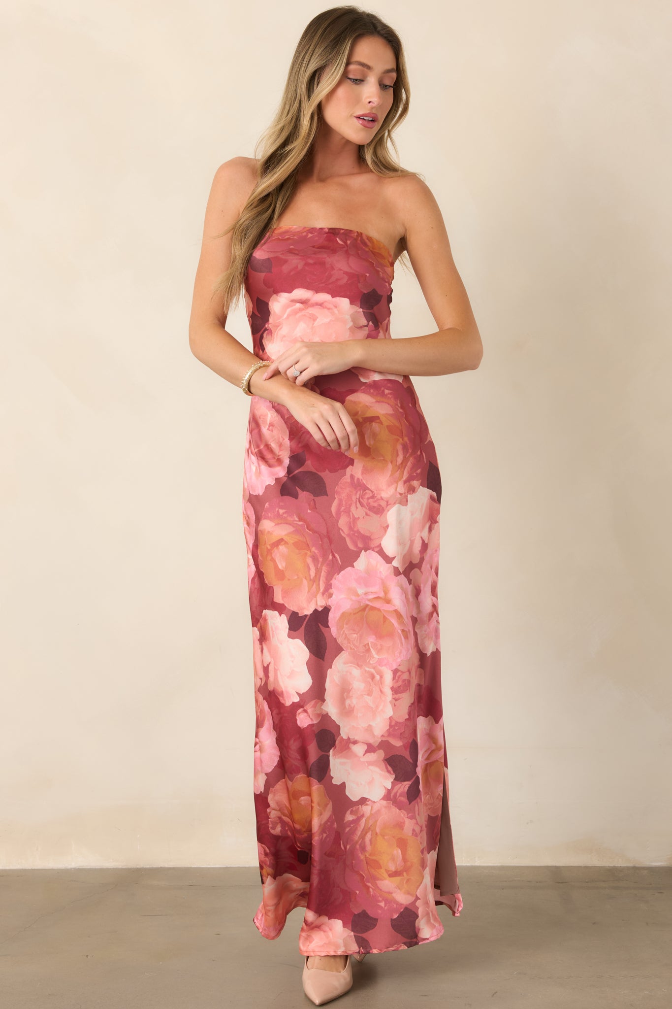 Elegant floral maxi dress in blush, mauve, burgundy, and warm peach, featuring a smooth strapless neckline and flowing floor-length silhouette.