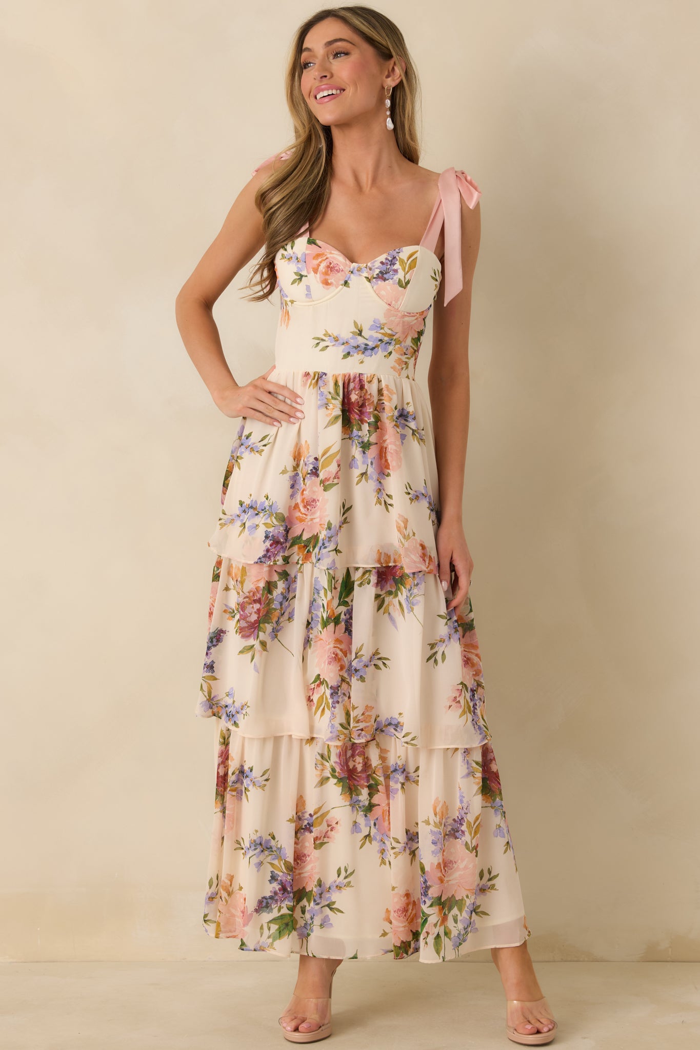 Blush pink multi maxi dress with a tiered ankle-length skirt and a soft, flowing drape.