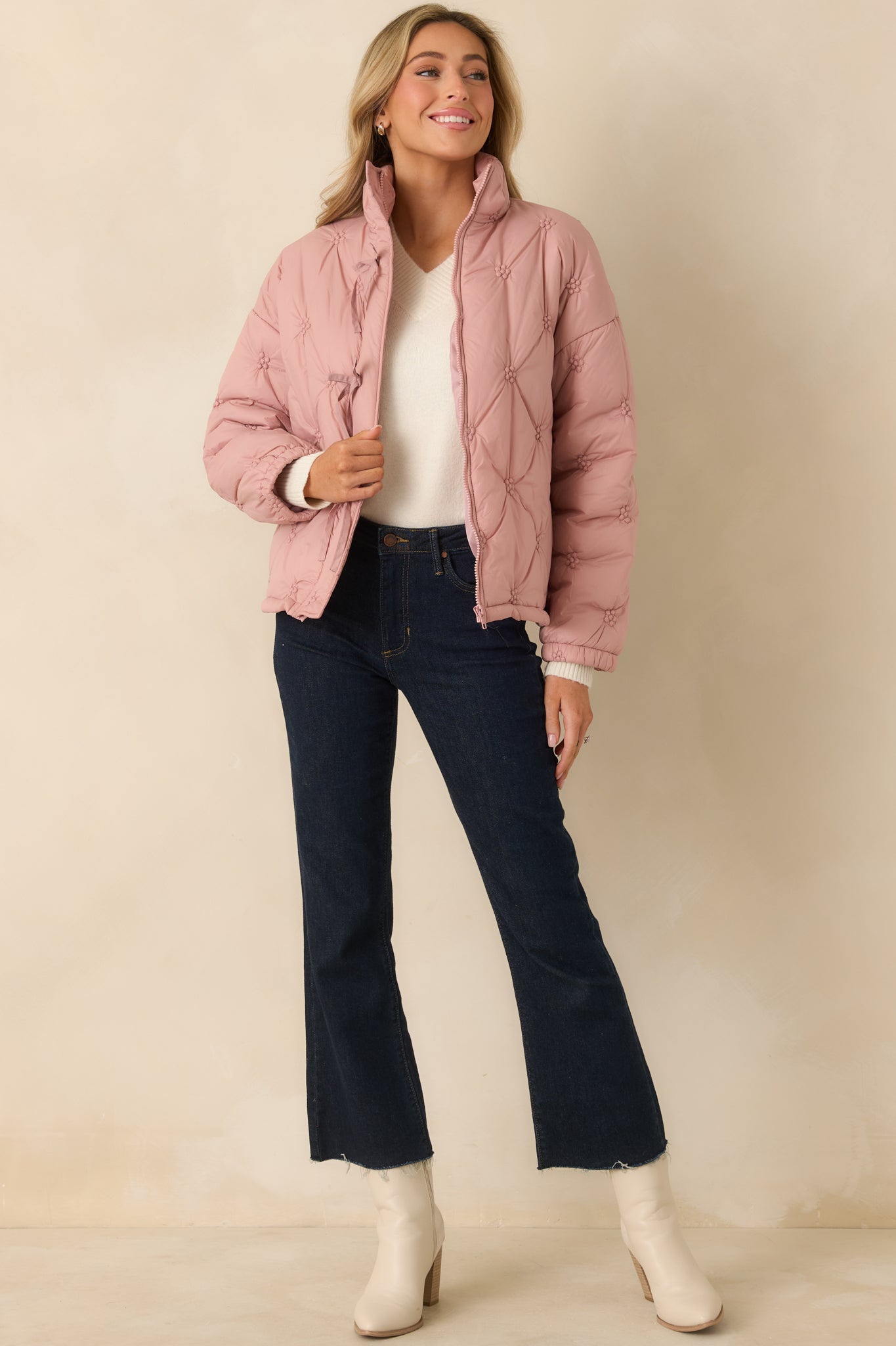 Blush pink quilted puffer jacket with stand collar, long sleeves, and relaxed fit showcasing the allover floral-inspired stitch pattern.